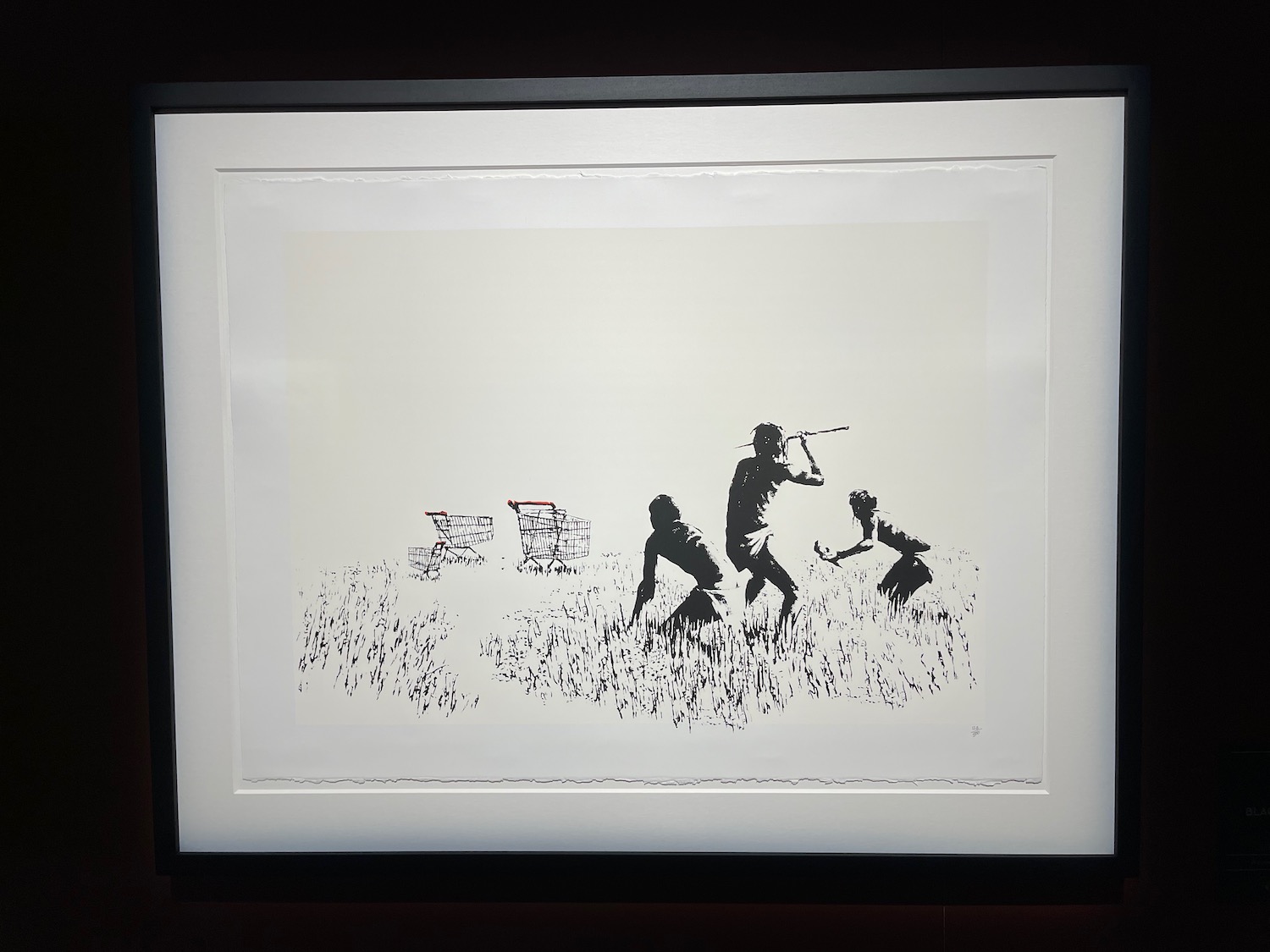 a framed picture of a group of people playing in a field