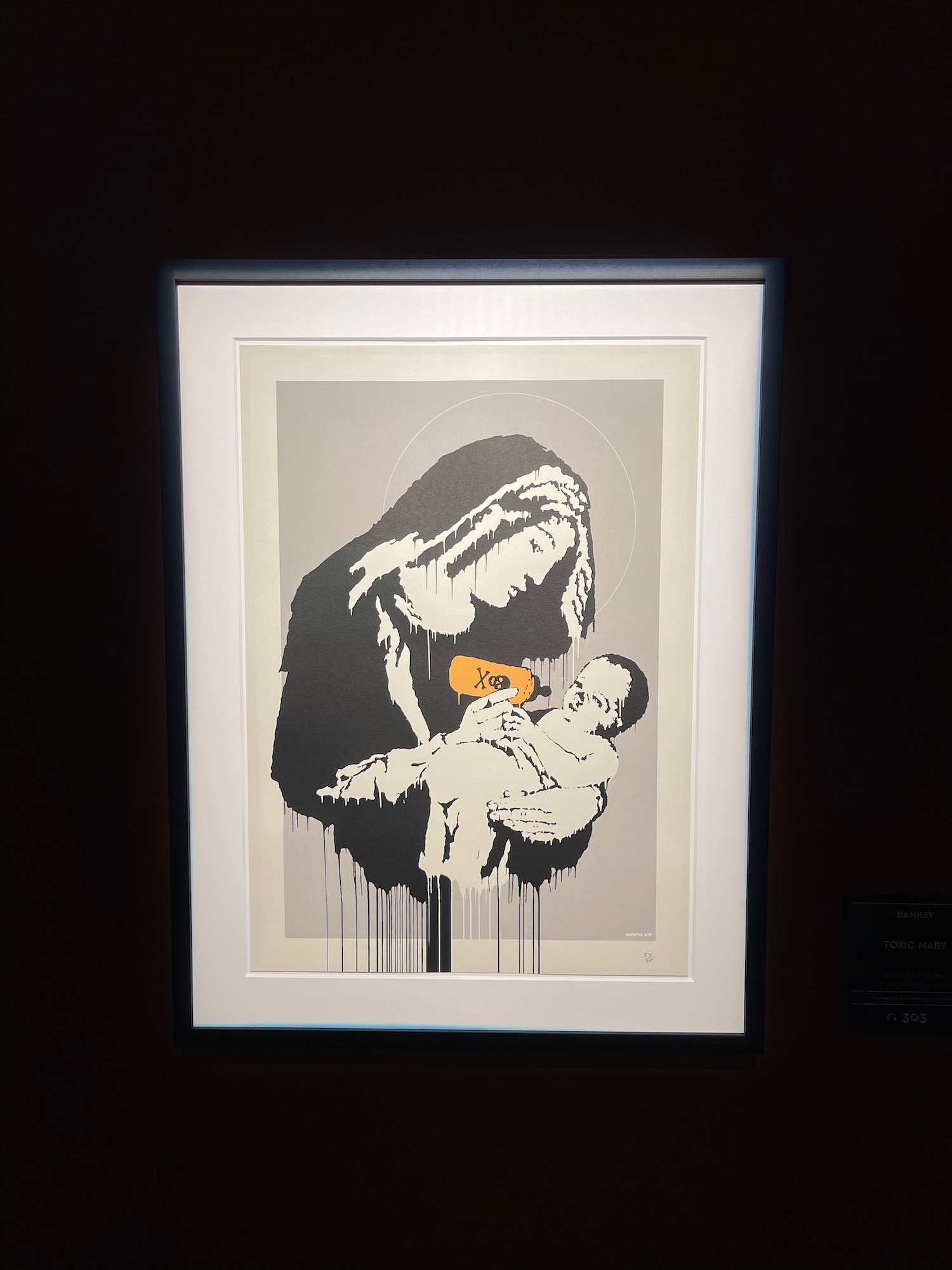 a framed picture of a woman holding a baby