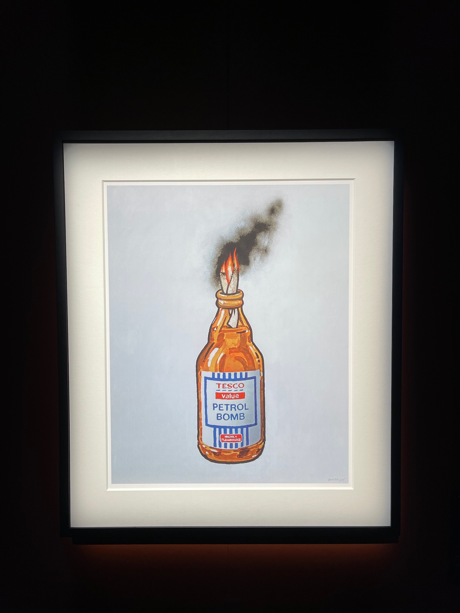 a picture of a bottle with a fire in it