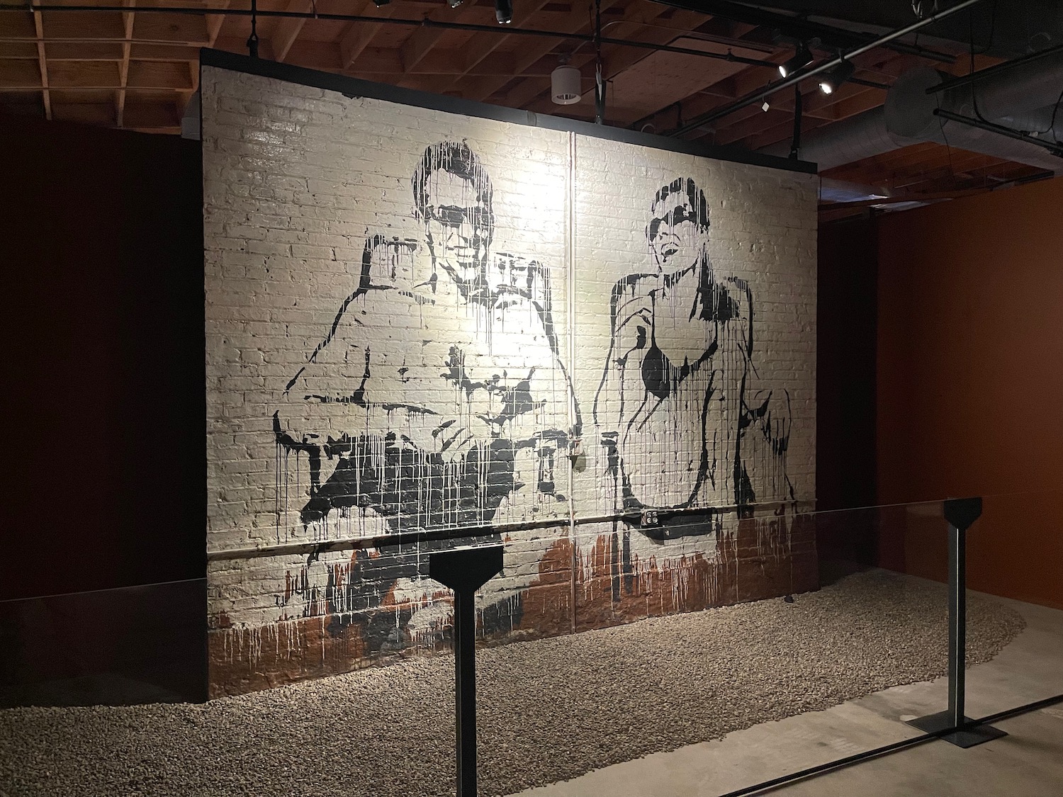 a mural of a couple of people on a brick wall