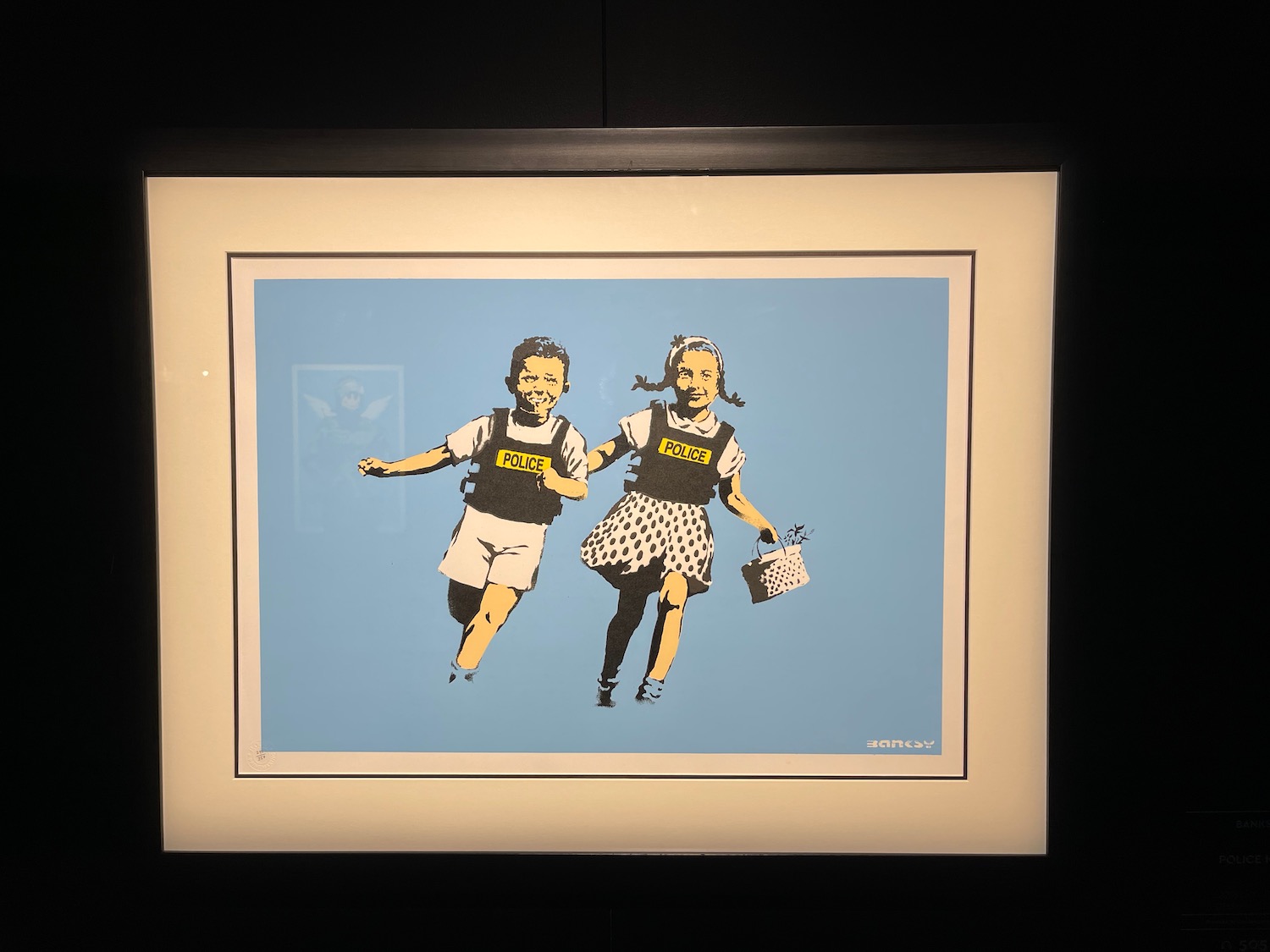 a framed picture of two children running