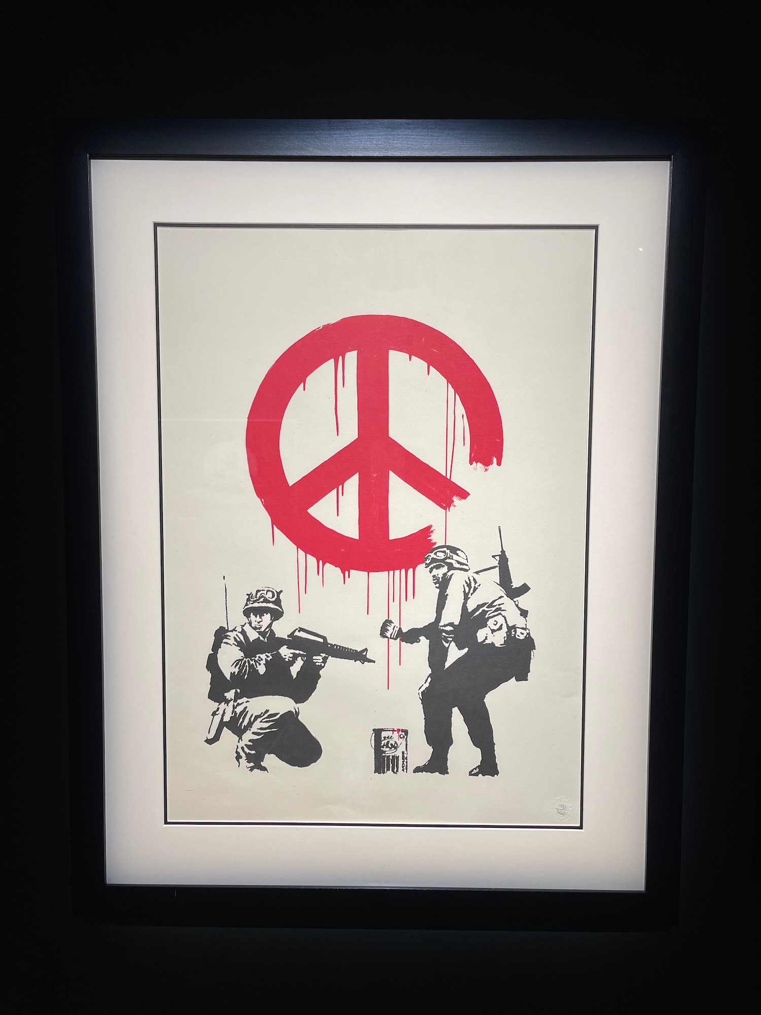 a framed picture of a peace sign and soldiers