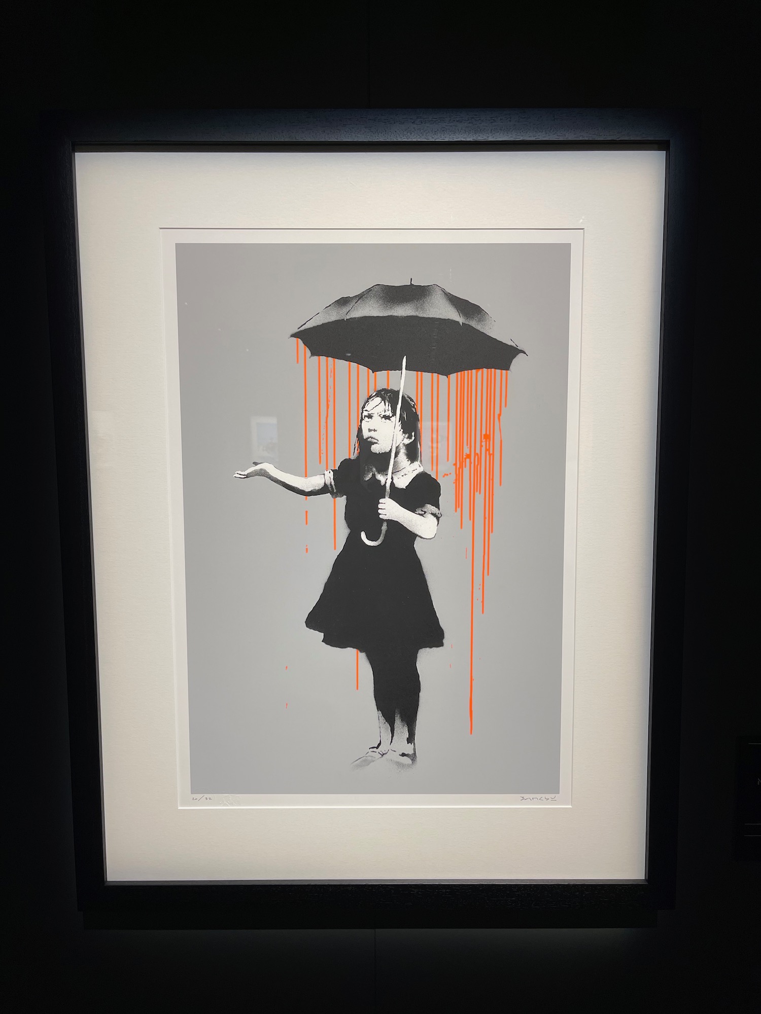 a framed picture of a girl holding an umbrella