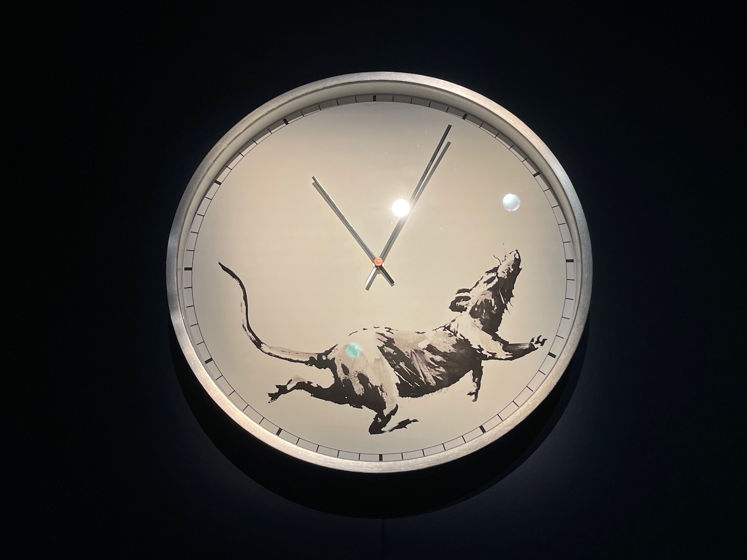 a clock with a rat on it