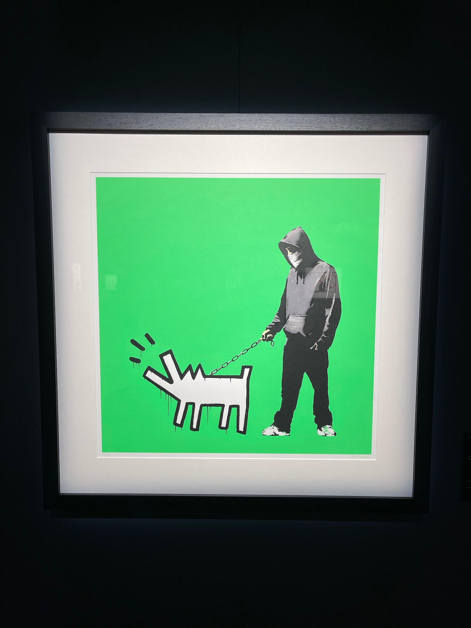 a framed picture of a man holding a dog