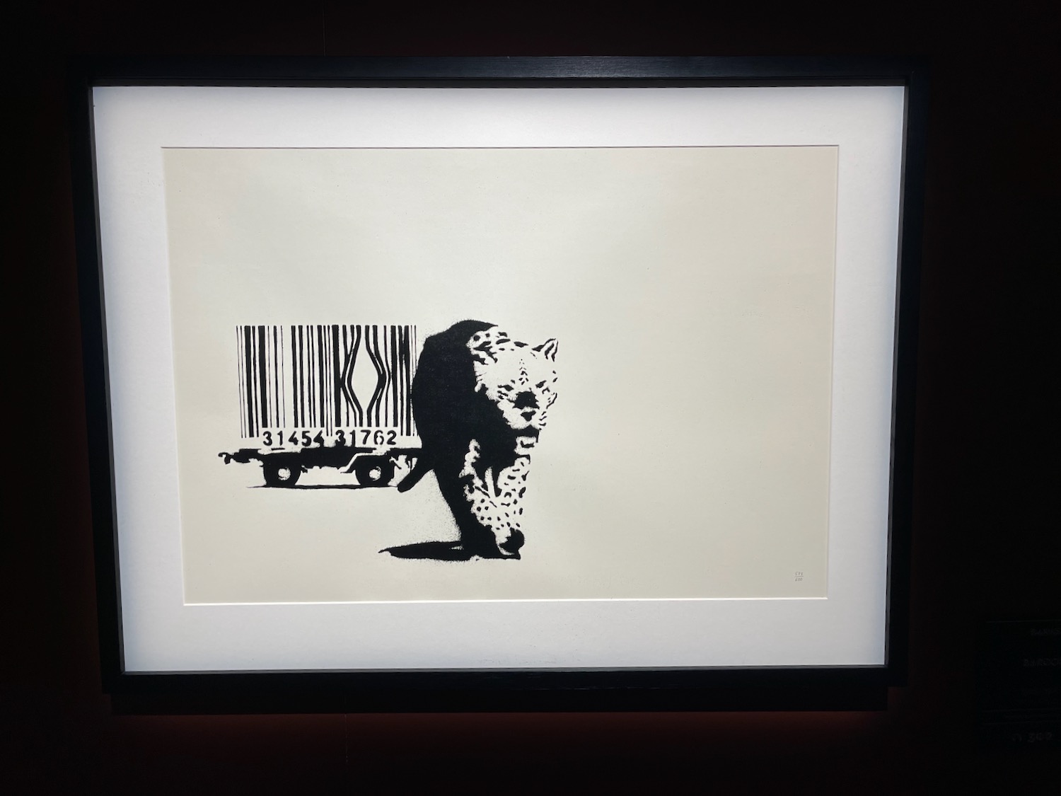 a framed picture of a bear and a barcode