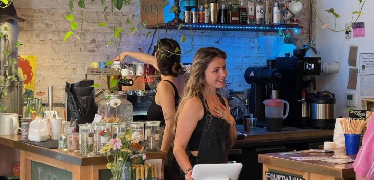 a woman standing behind a counter