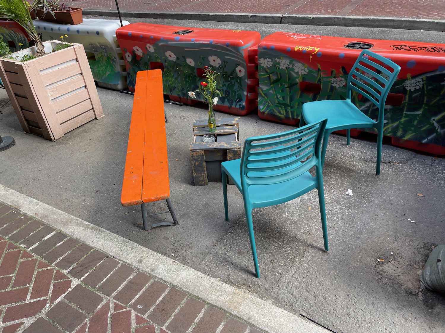 a group of chairs and benches on a sidewalk
