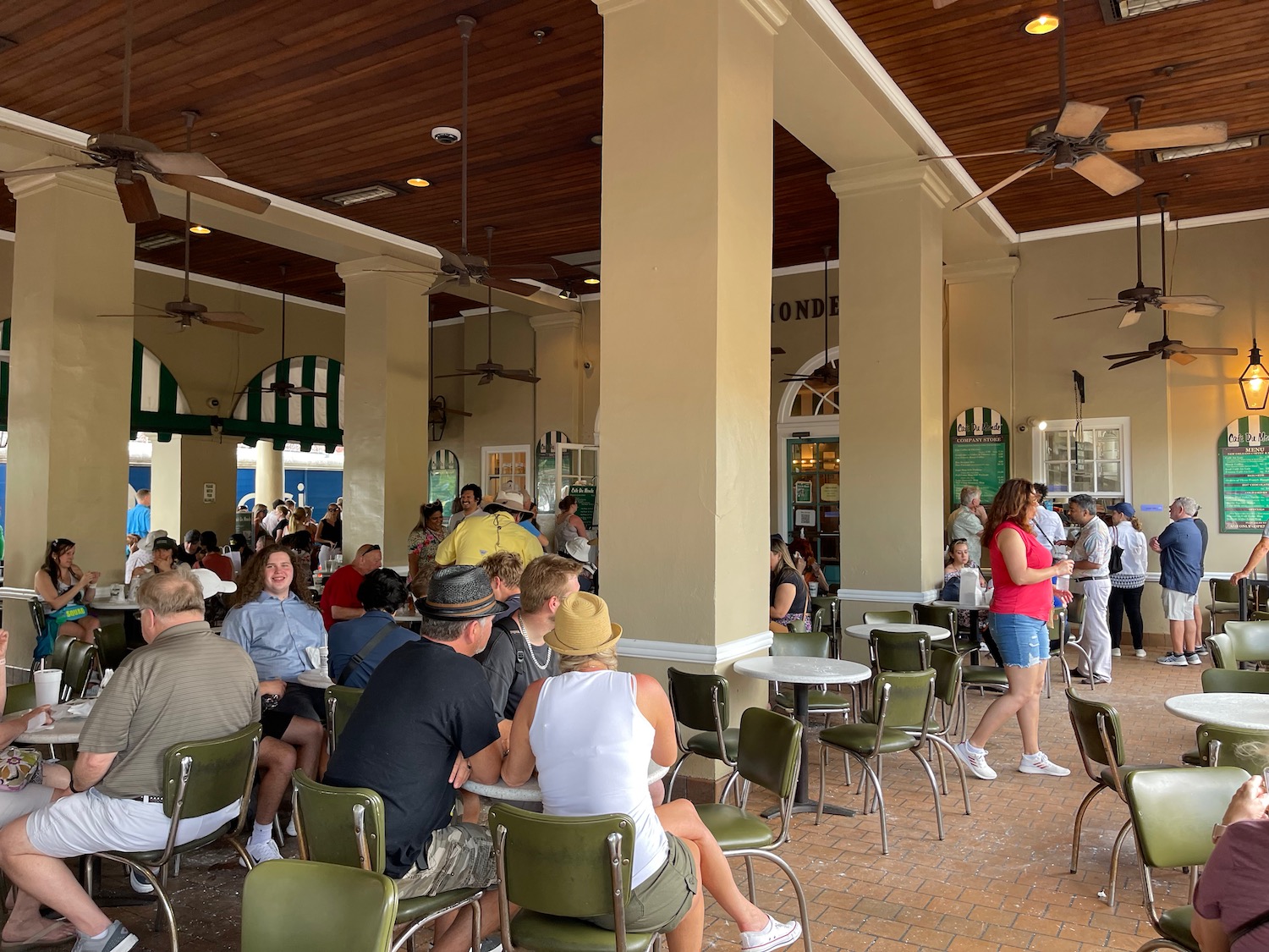 a group of people sitting at tables in a restaurant