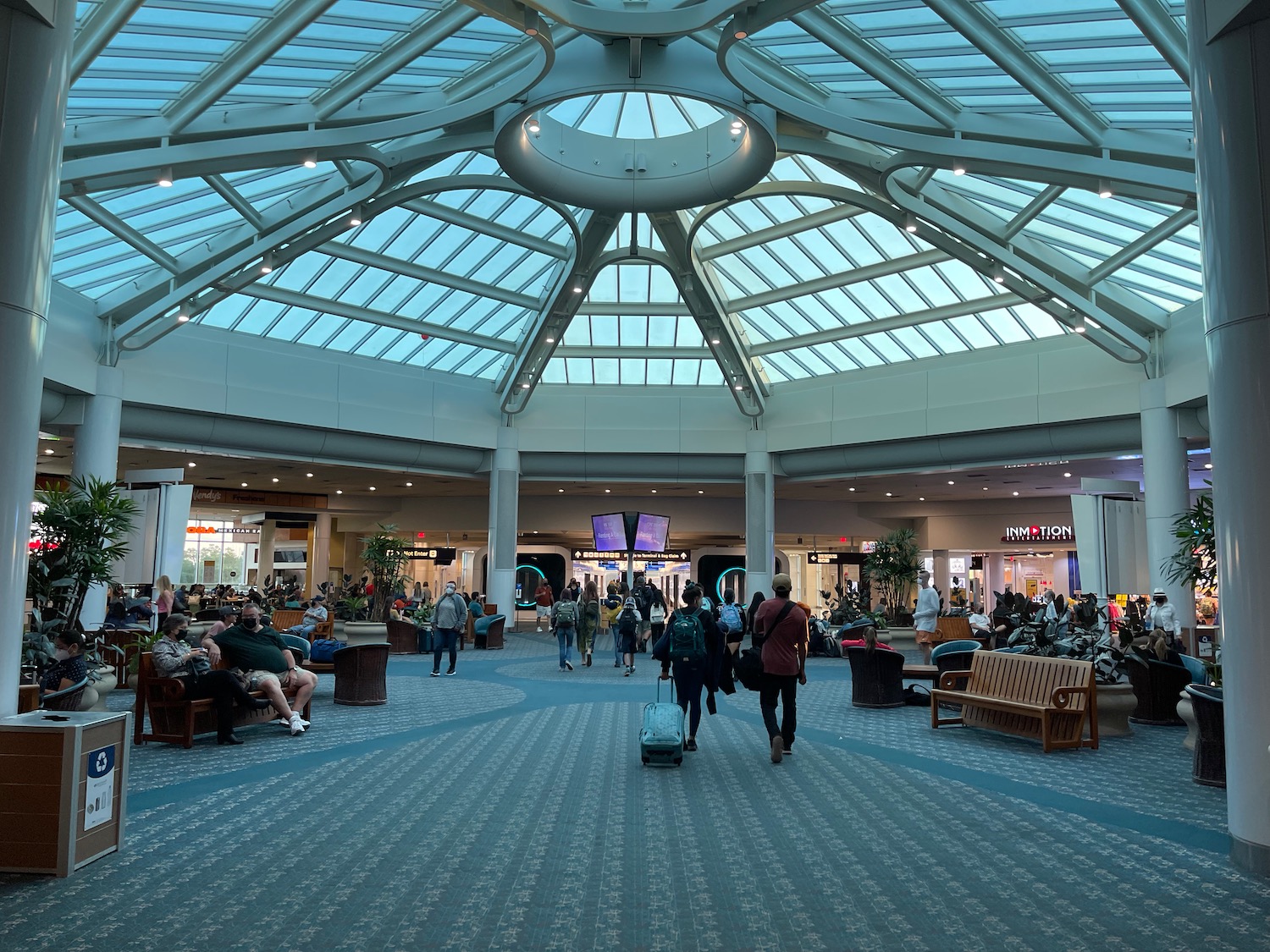 people walking in a large airport terminal