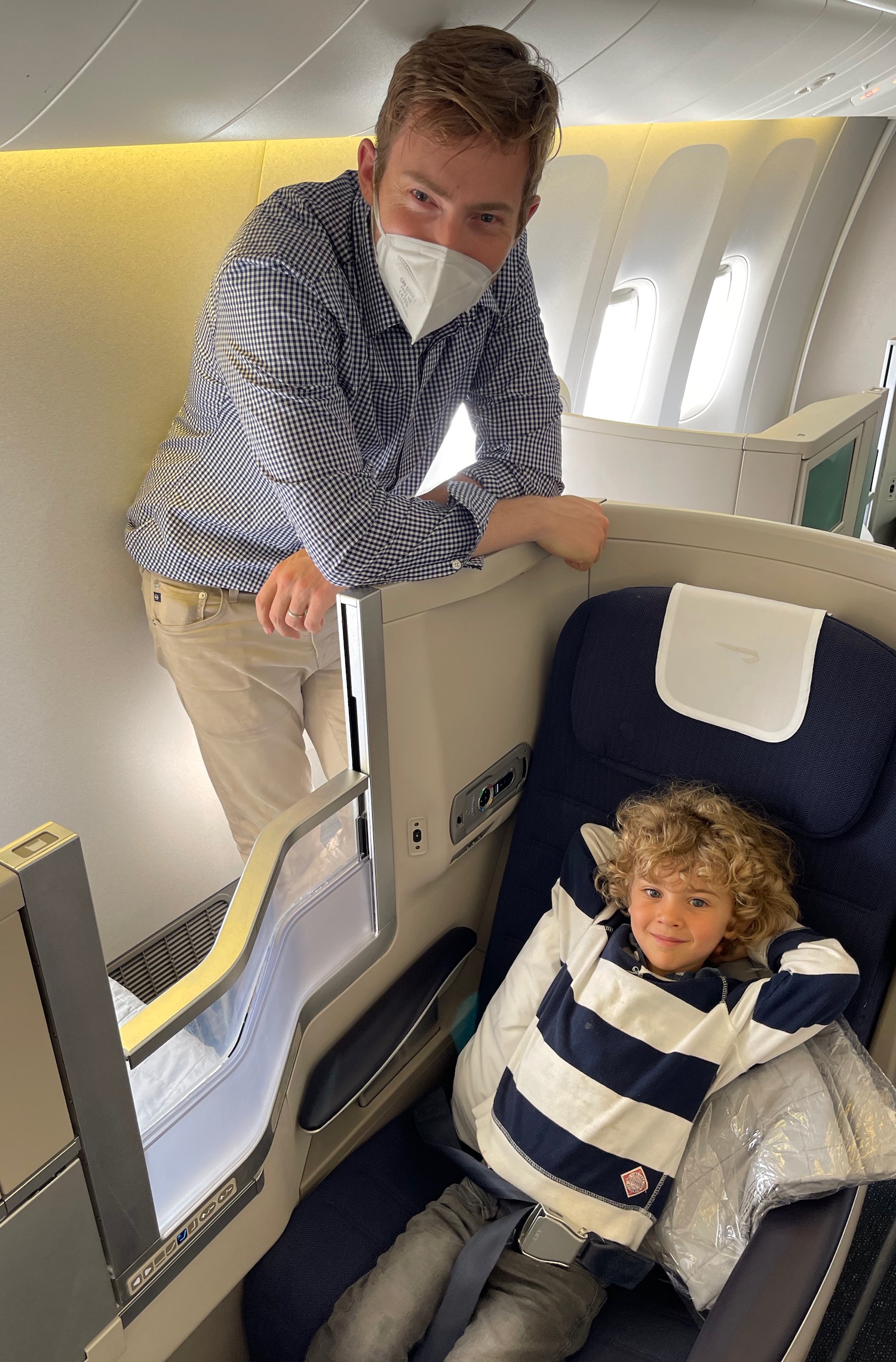 a man and child in a plane