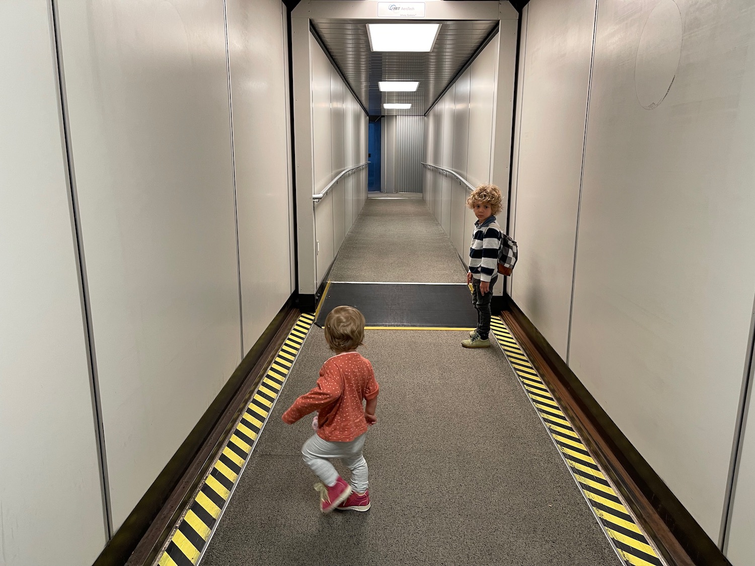 a two children walking down a hallway