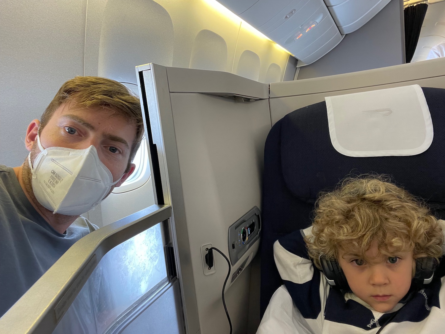 a man and child in a plane