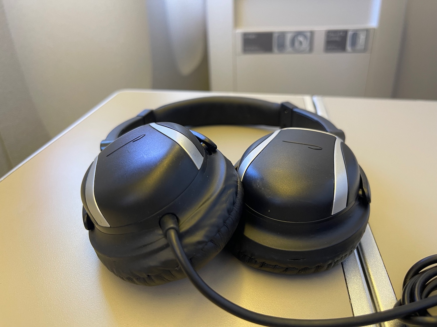 a pair of black headphones on a white surface