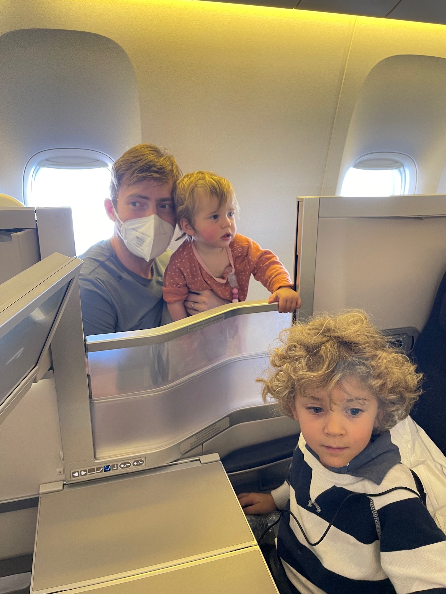 a man and two children on an airplane