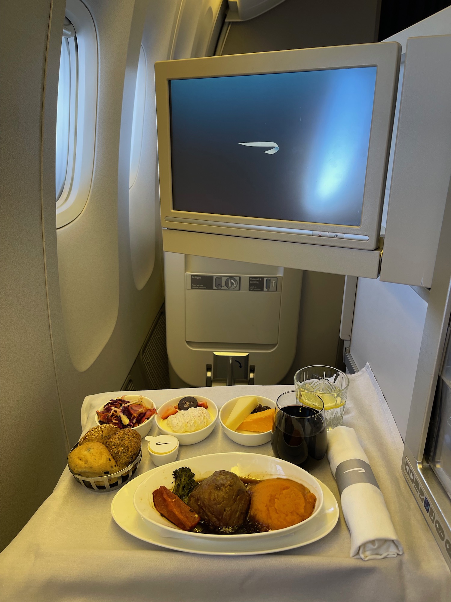 a tray of food on a table with a television in the background