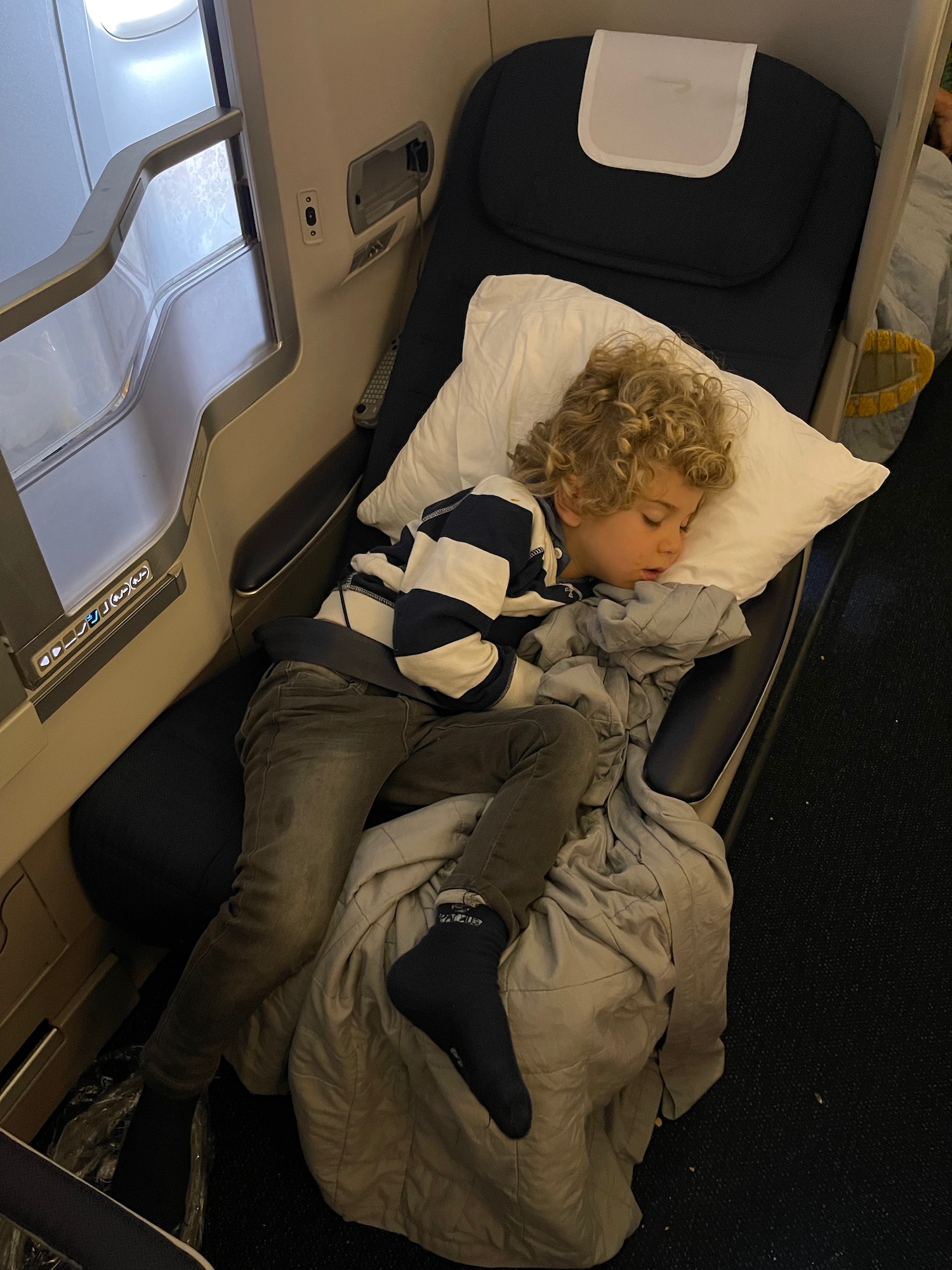 a child sleeping on a bed