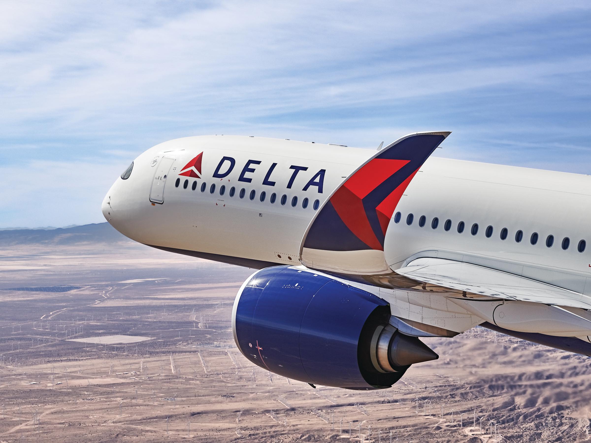 a plane flying over a desert