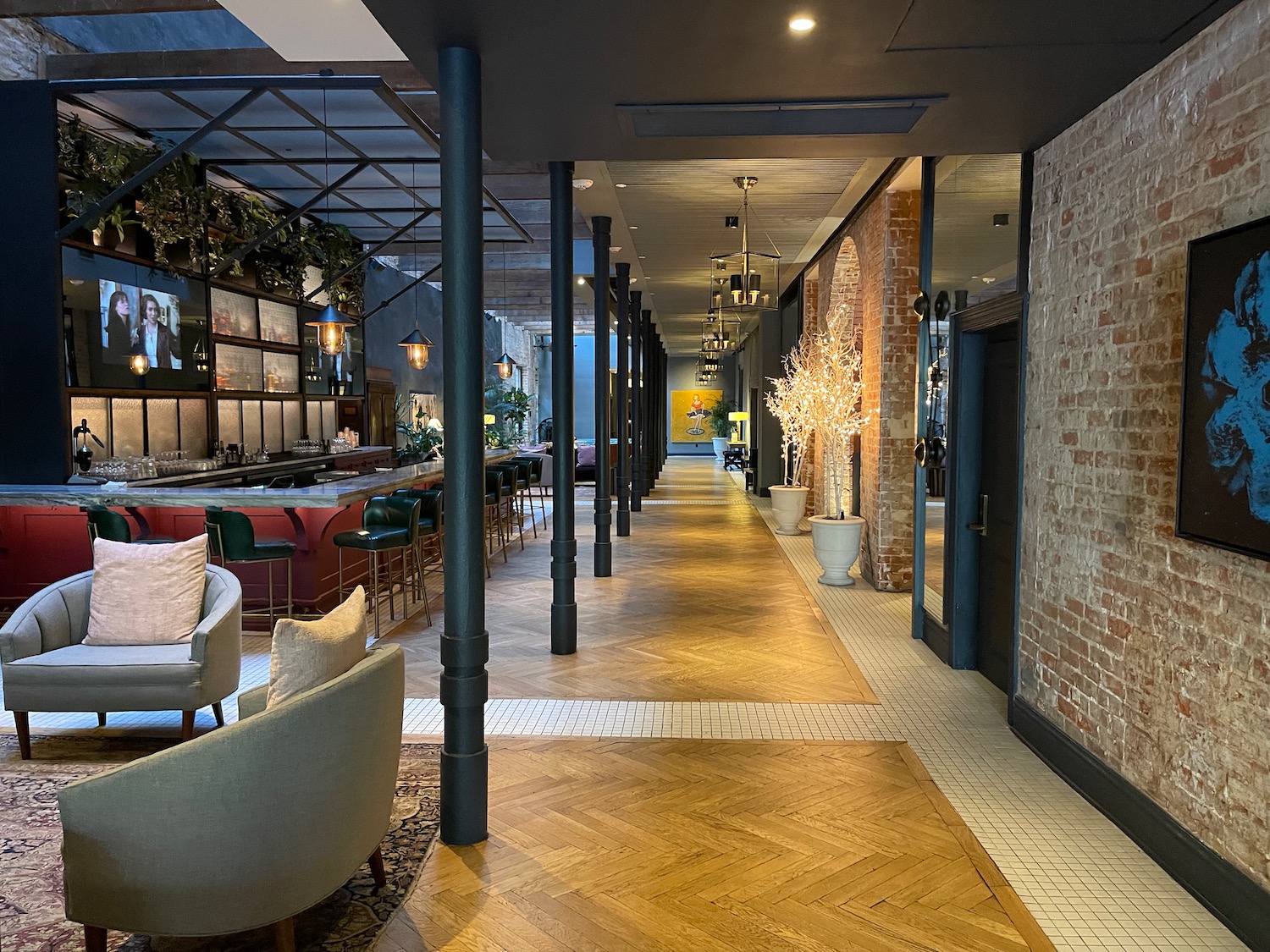 a long hallway with brick walls and a bar