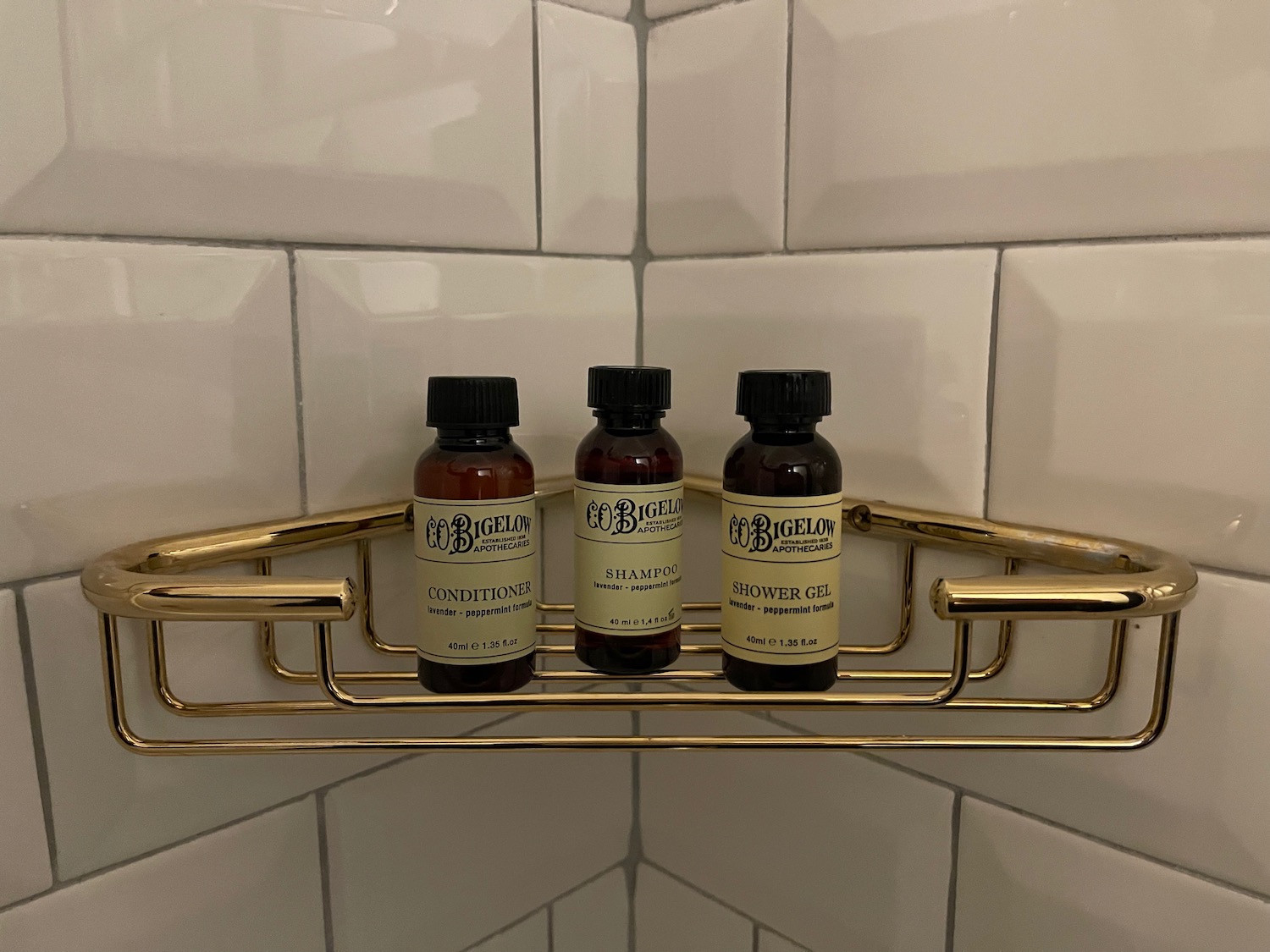bottles of shampoo on a gold shelf