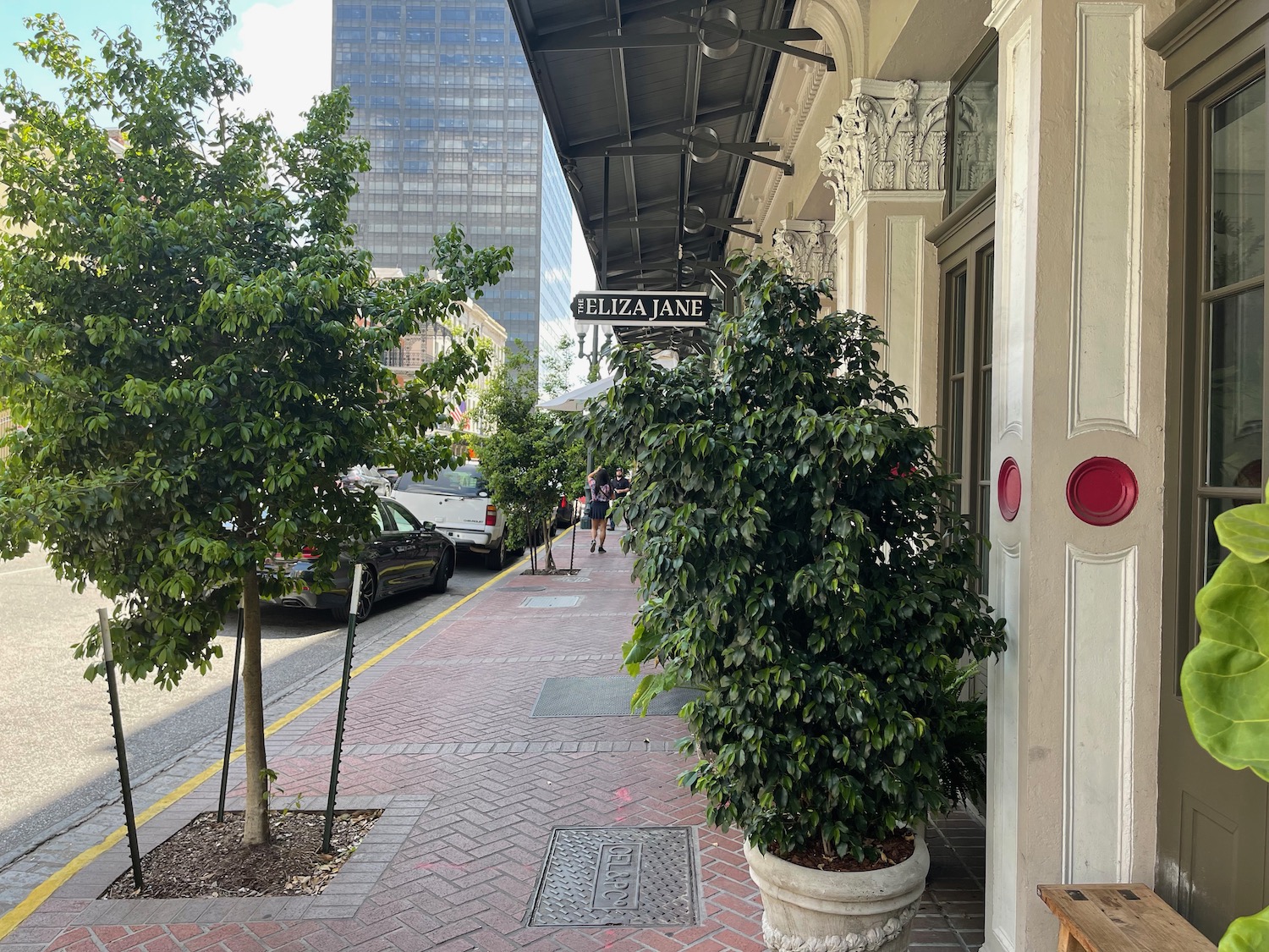 a building with trees and a sign on the side