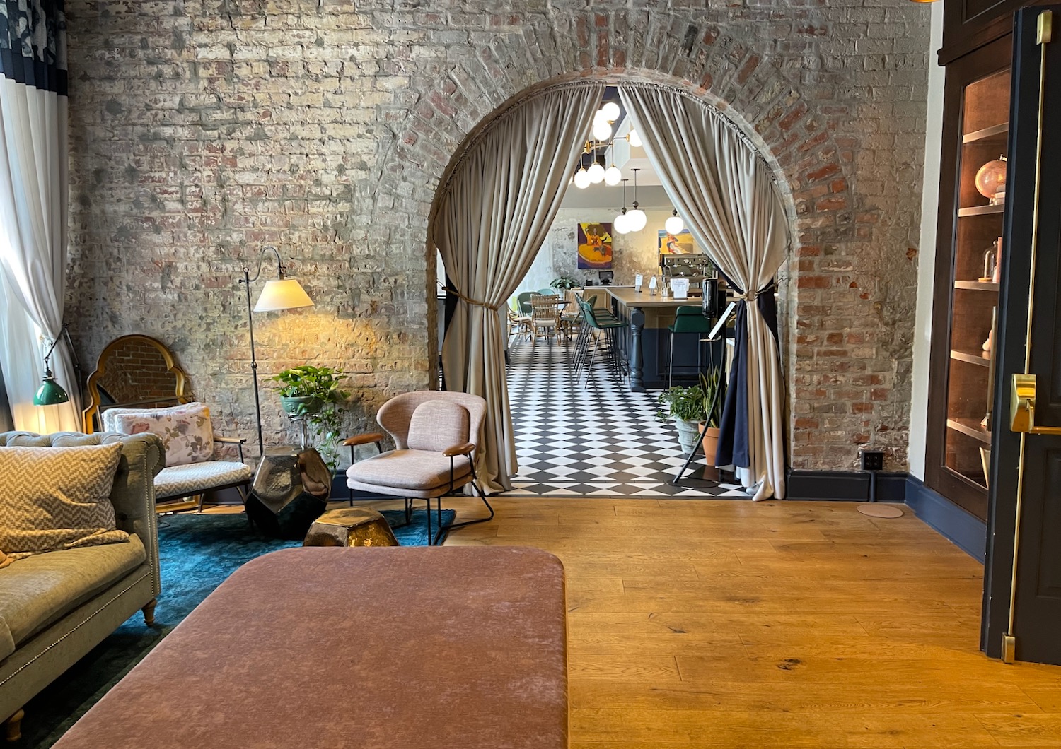 a room with a brick archway and a table and chairs