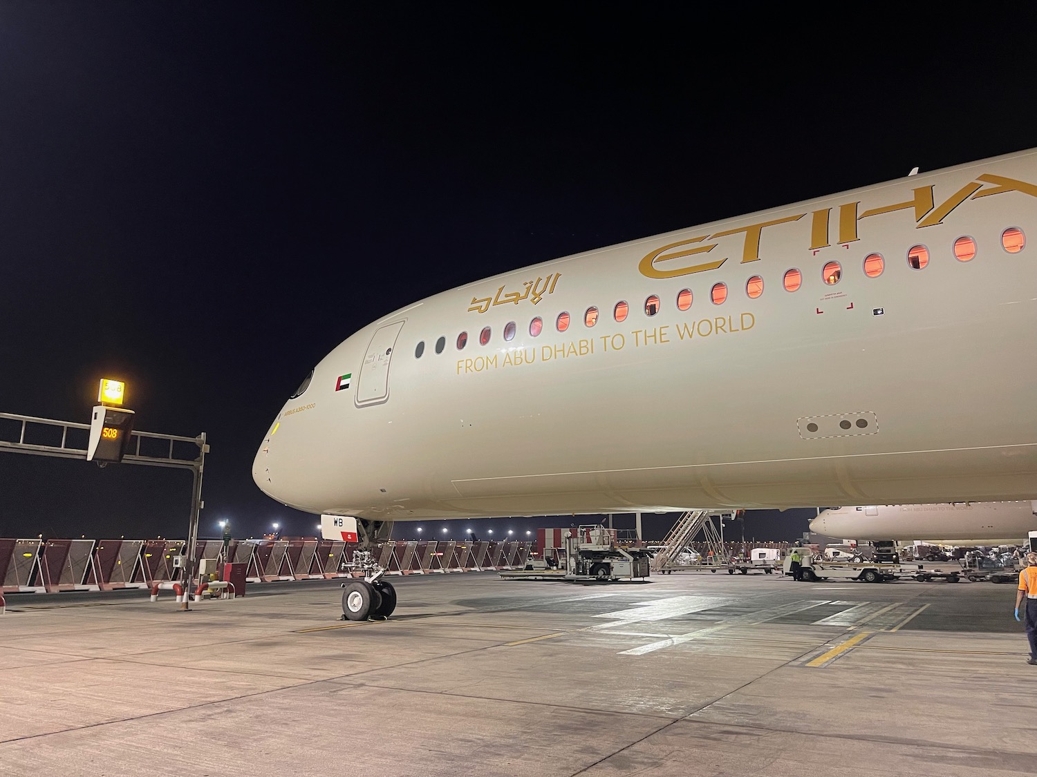 a large white airplane on a tarmac at night