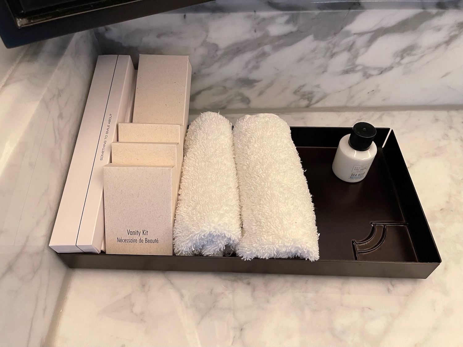 a tray with towels and a bottle of soap