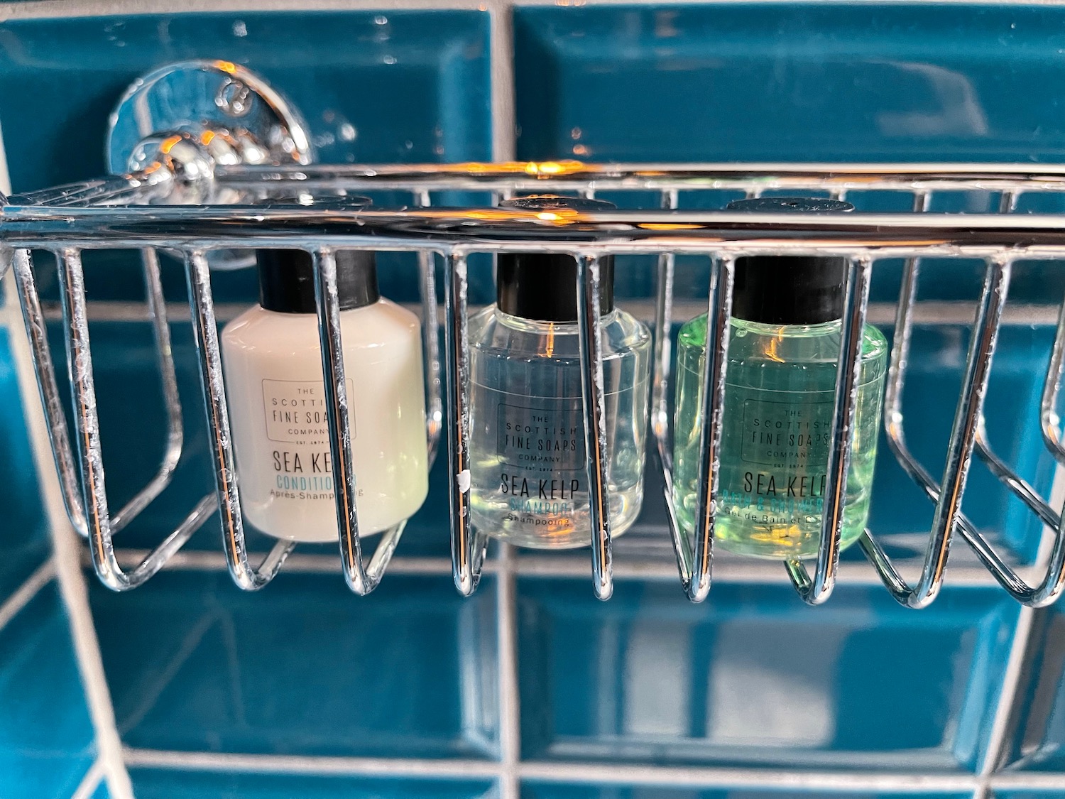 a group of small bottles of liquid in a metal rack