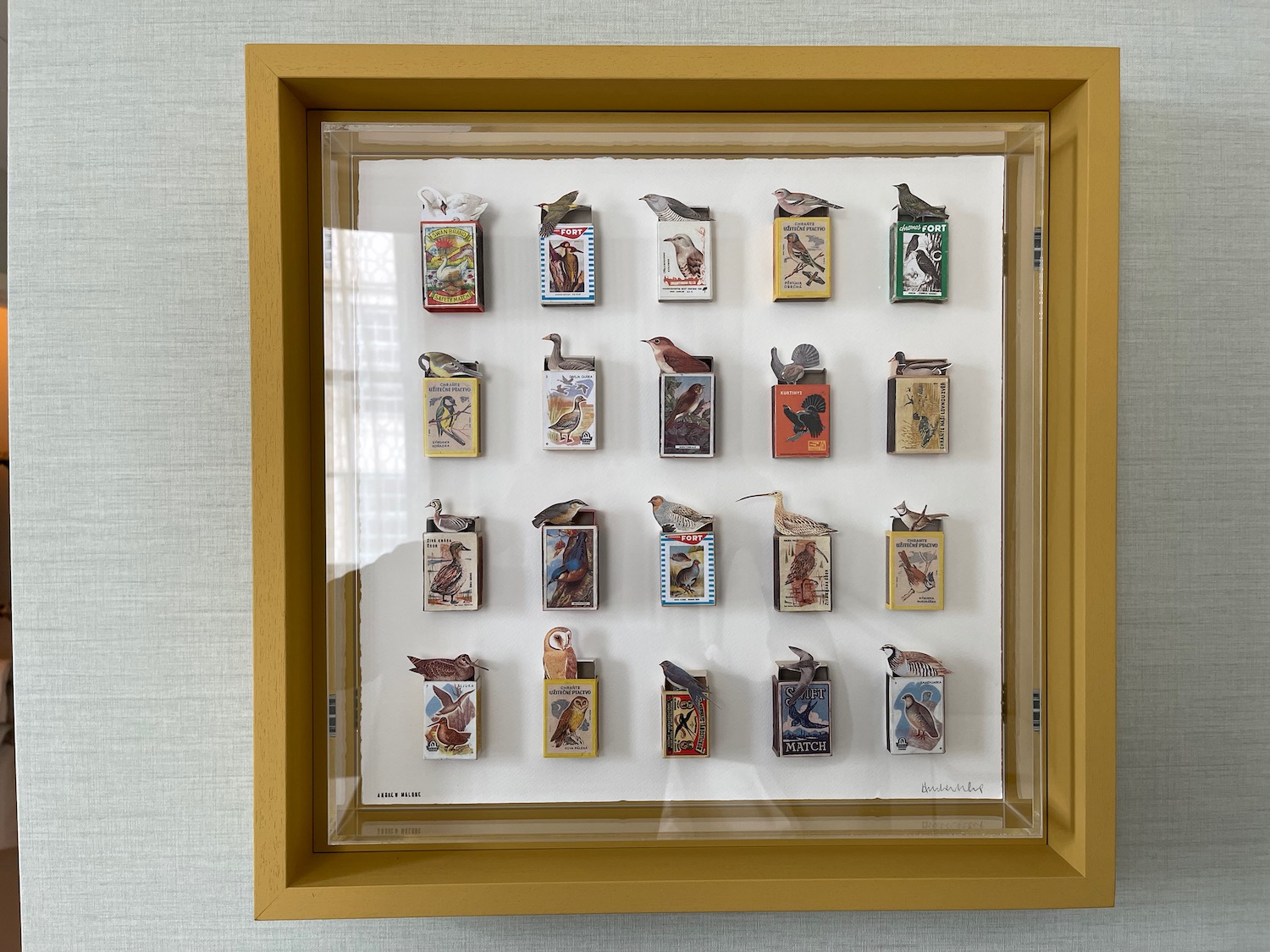 a display of matchboxes in a frame