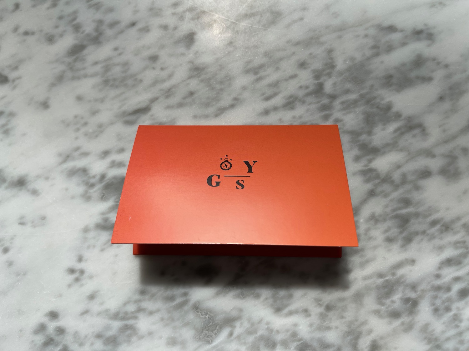 an orange box on a marble surface