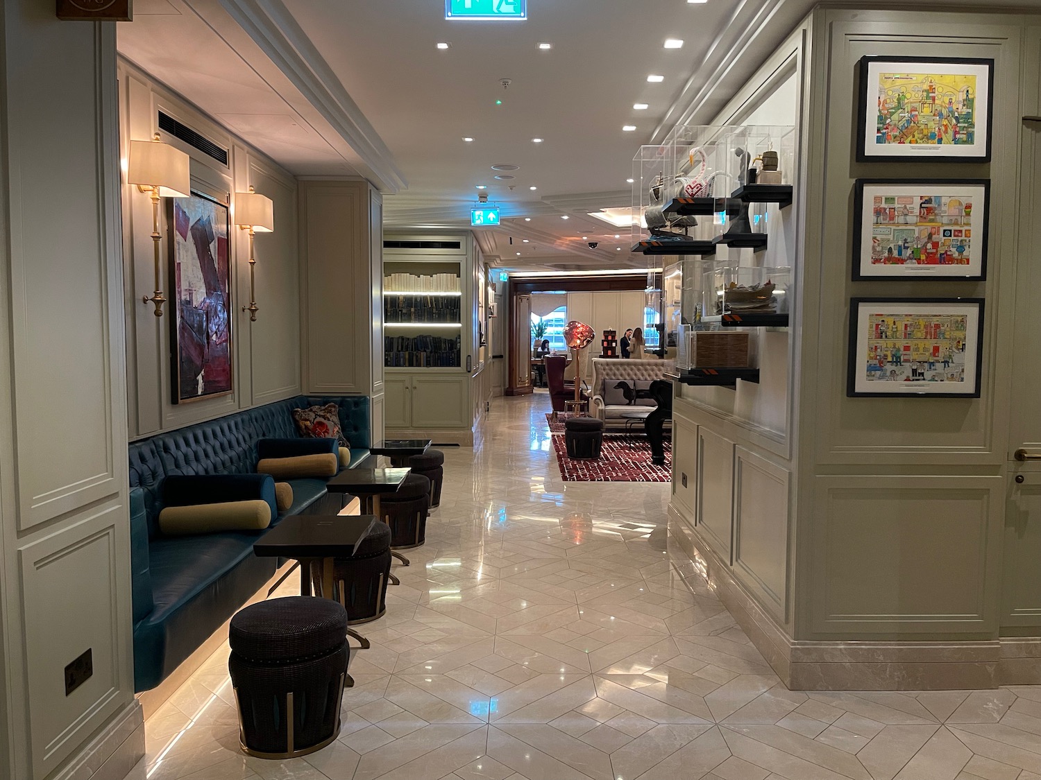 a hallway with a couch and tables