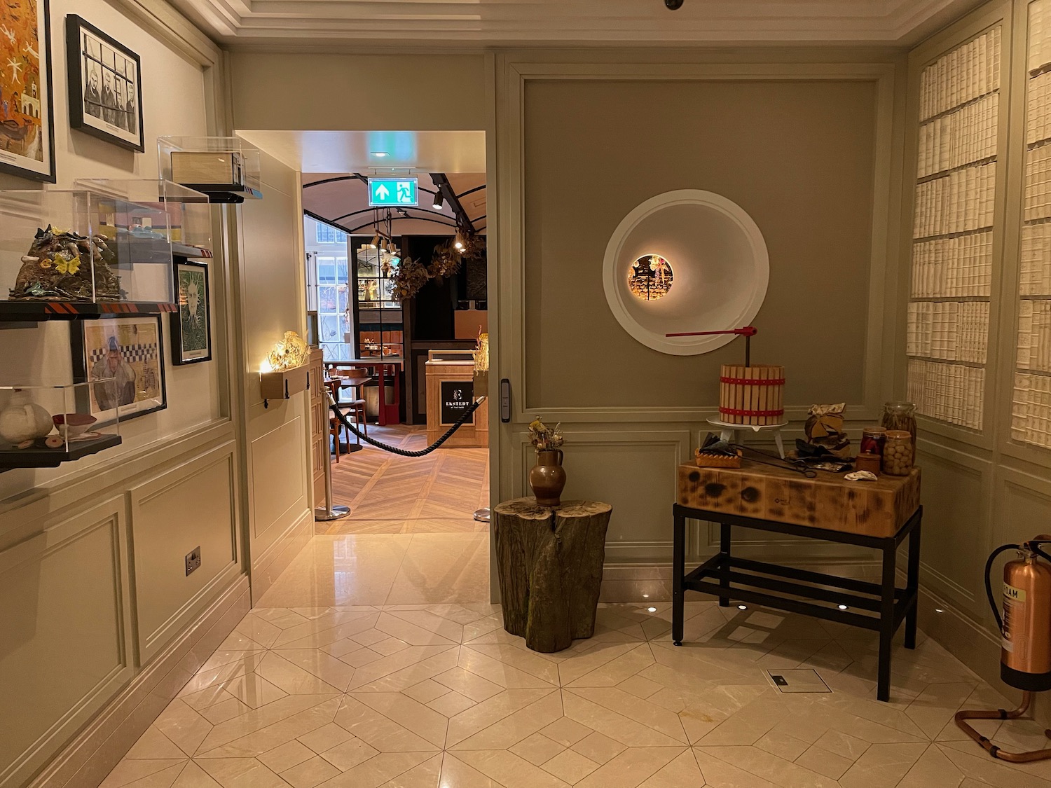 a hallway with a table and a vase on the side