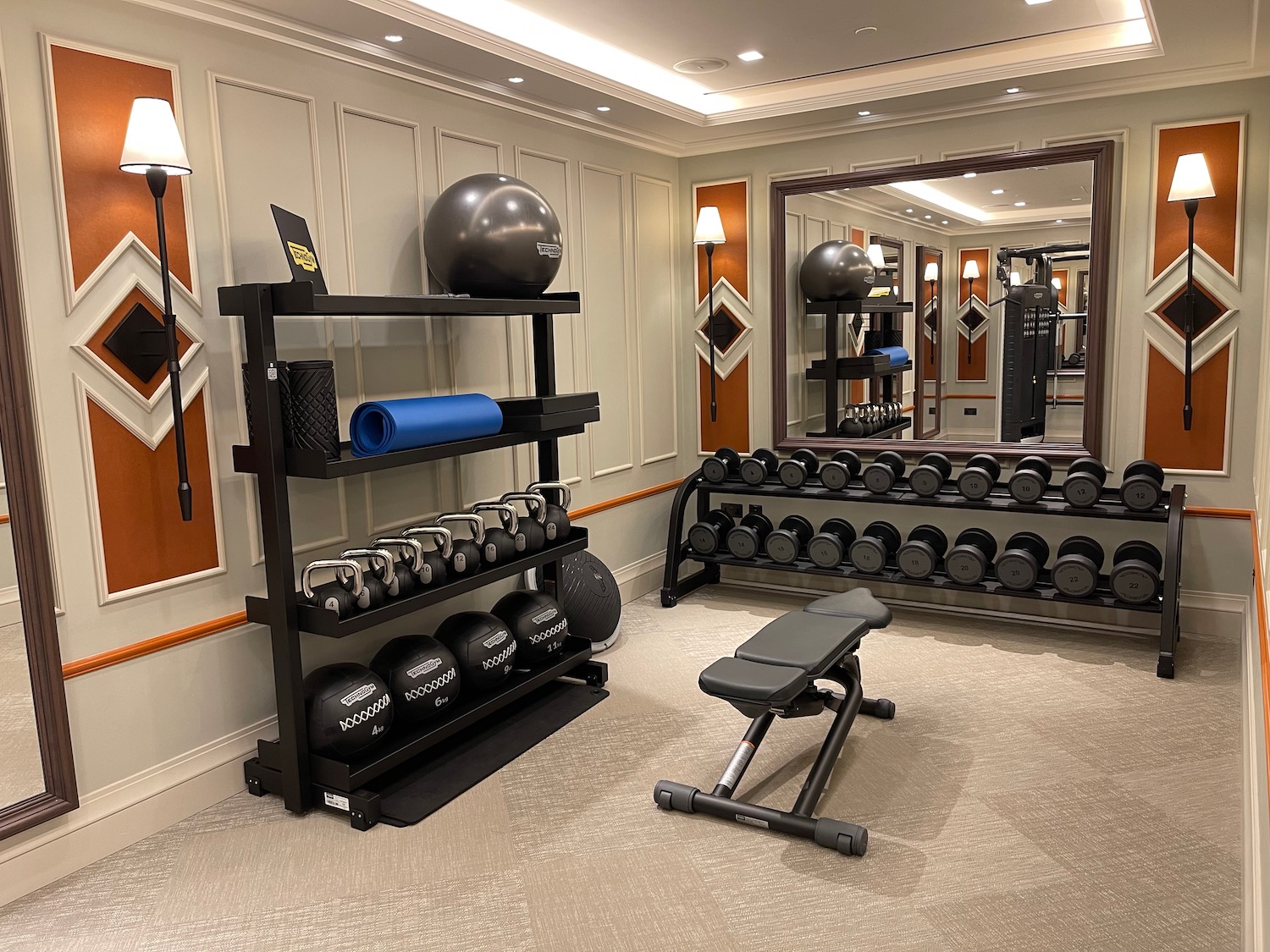 a room with a mirror and exercise equipment