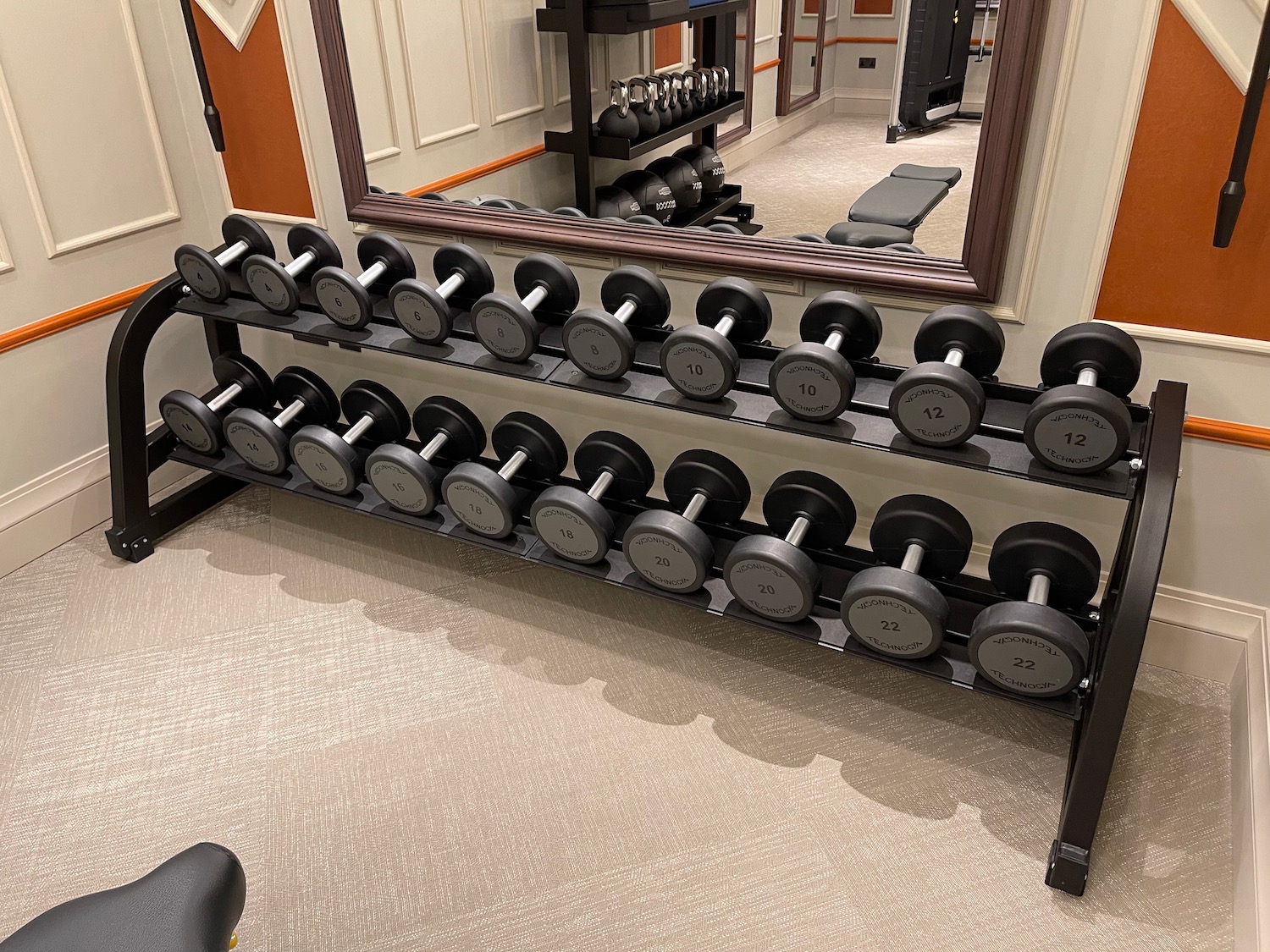 a rack of dumbbells in a room