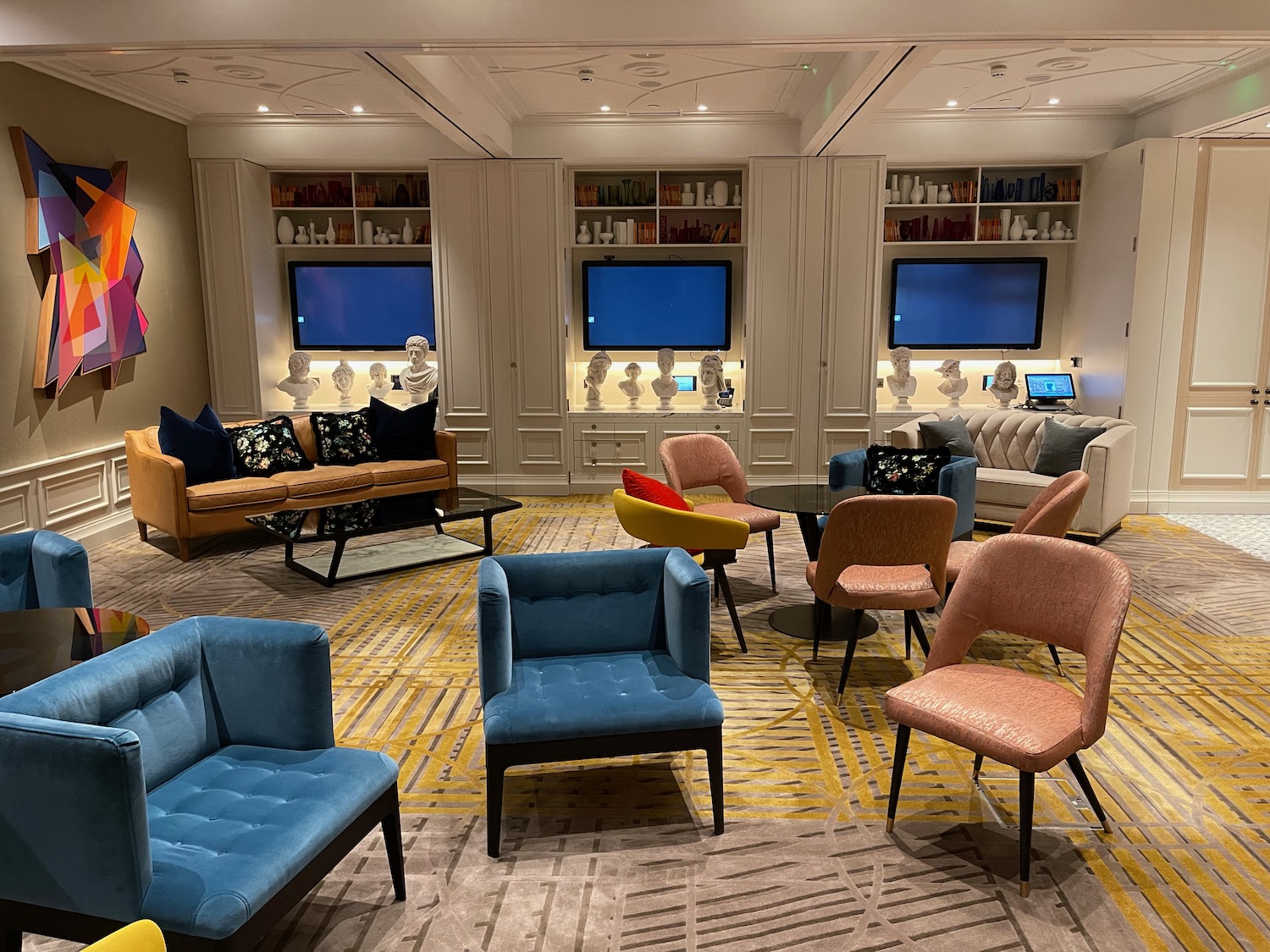 a room with a group of chairs and televisions