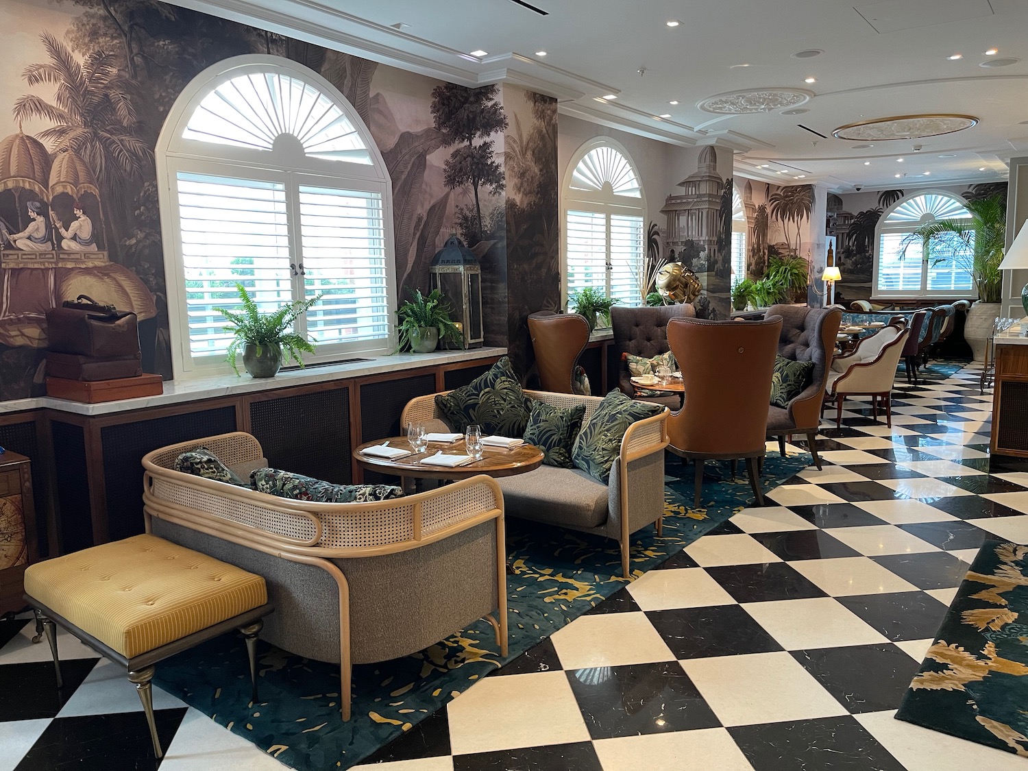 a room with a checkered floor and chairs and tables