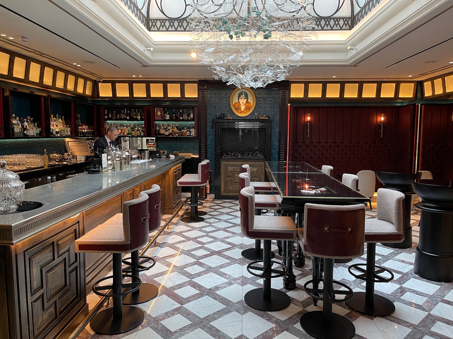 a bar with a glass ceiling and a man standing behind it