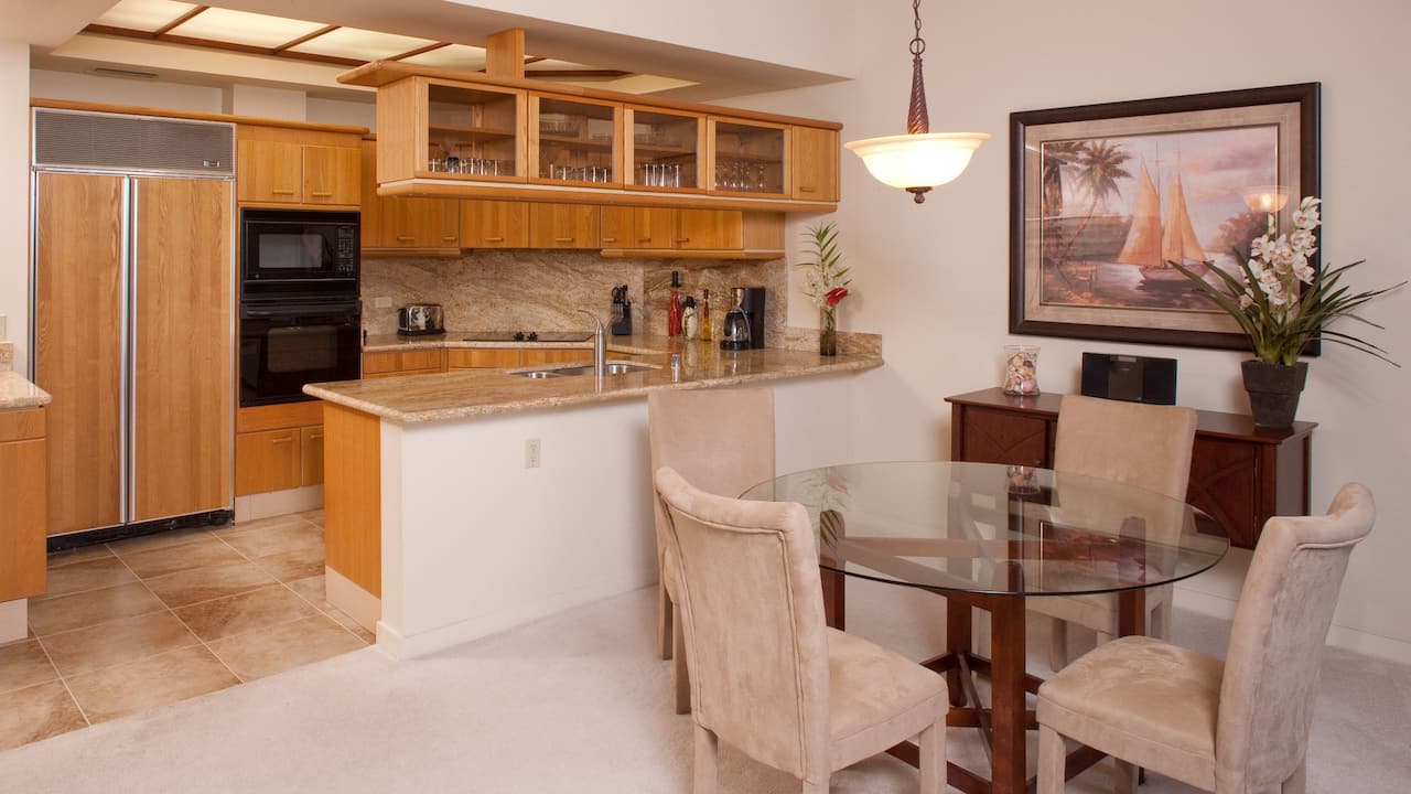 a kitchen with a table and chairs