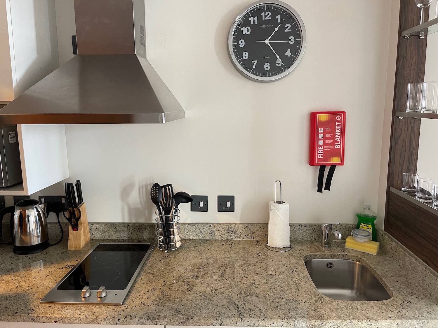 a kitchen counter with a clock on the wall