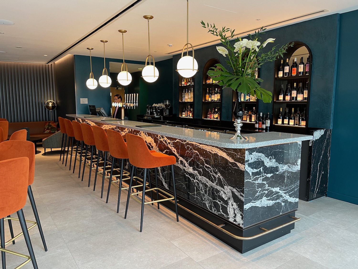 a bar with chairs and a counter