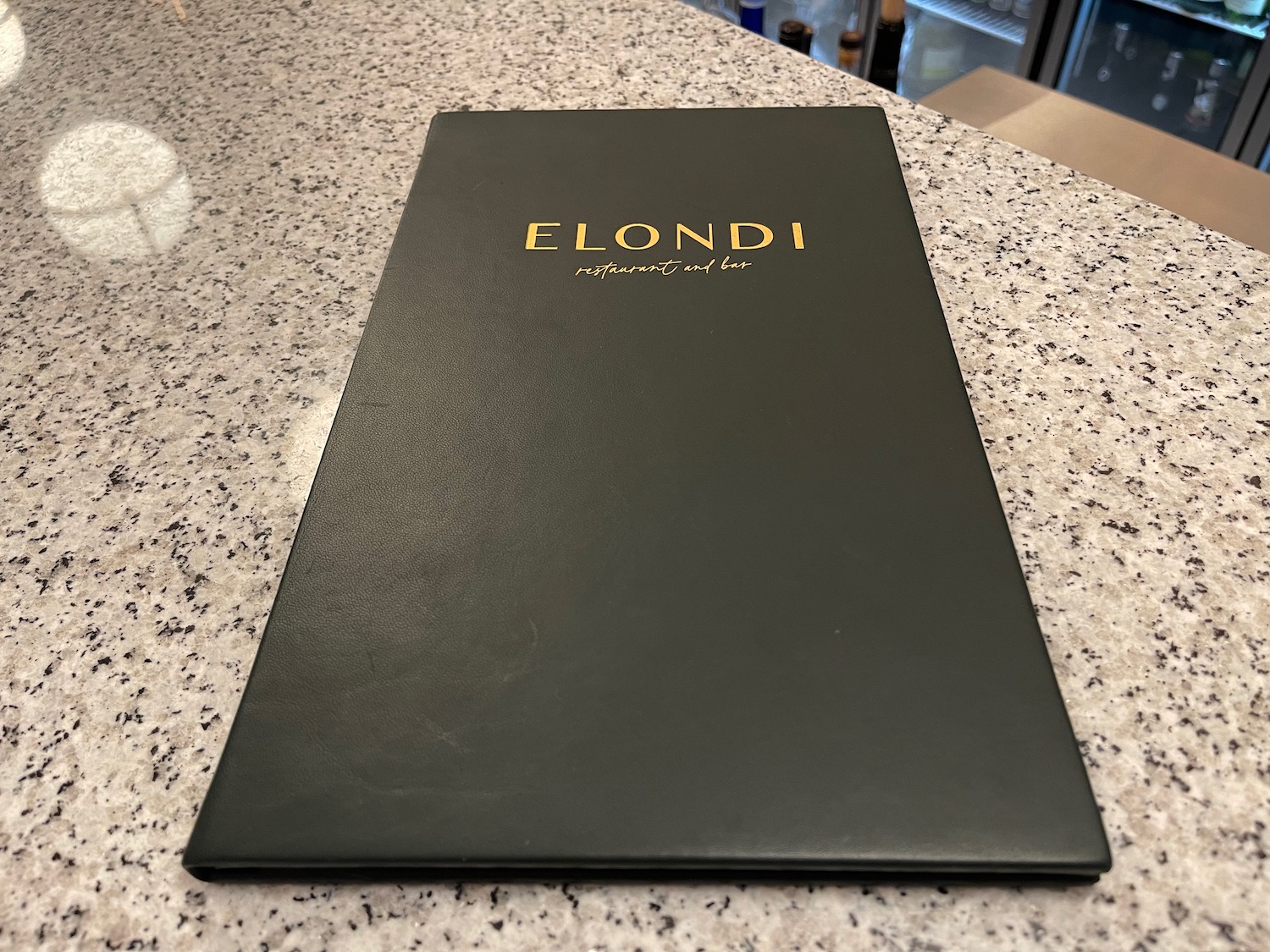 a black menu on a marble counter