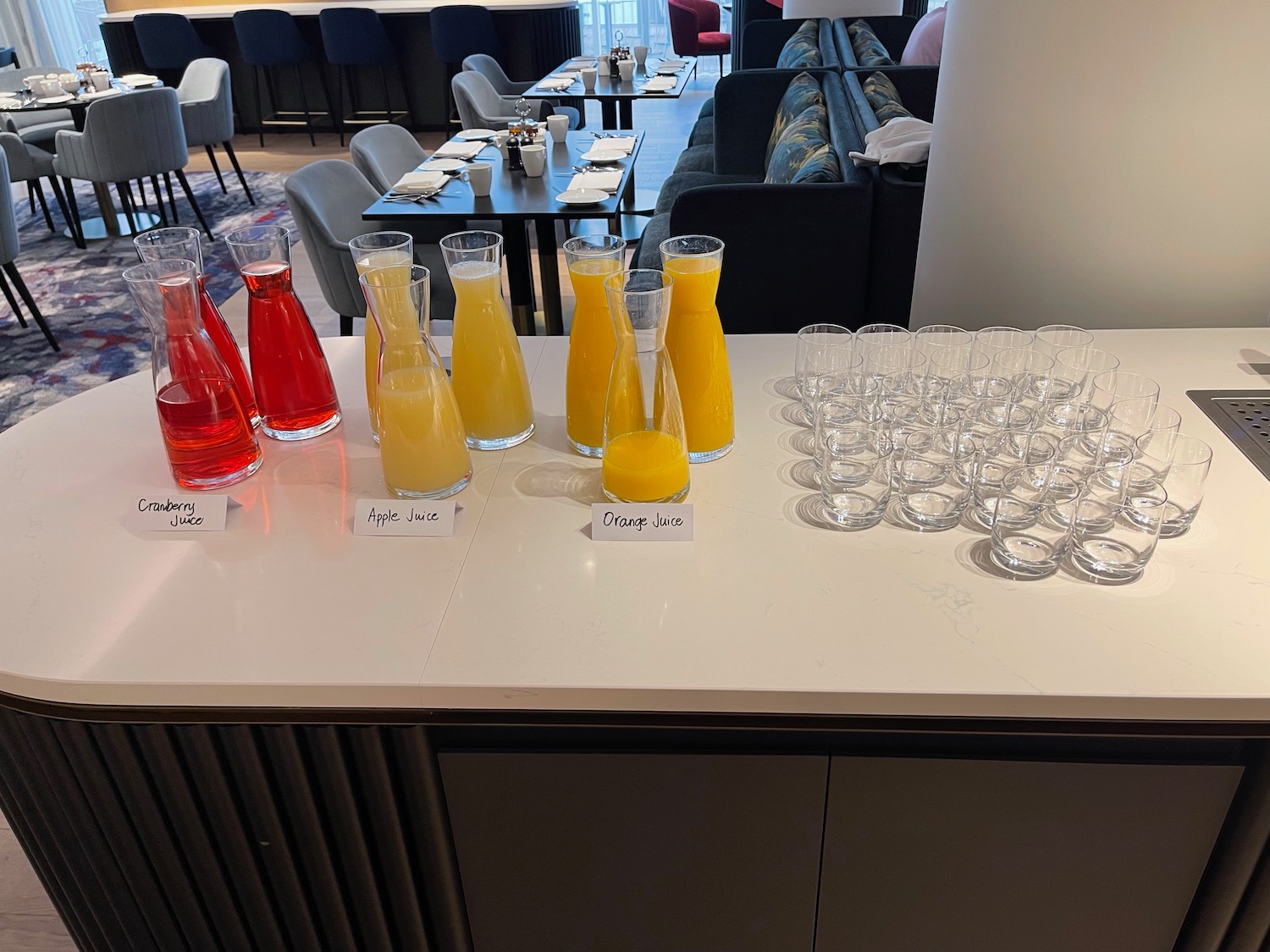 a table with glasses and bottles of juice