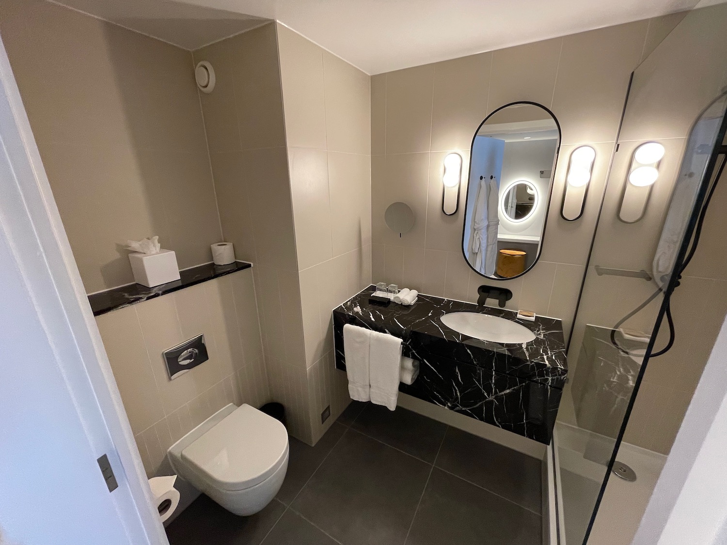 a bathroom with a sink toilet and mirror