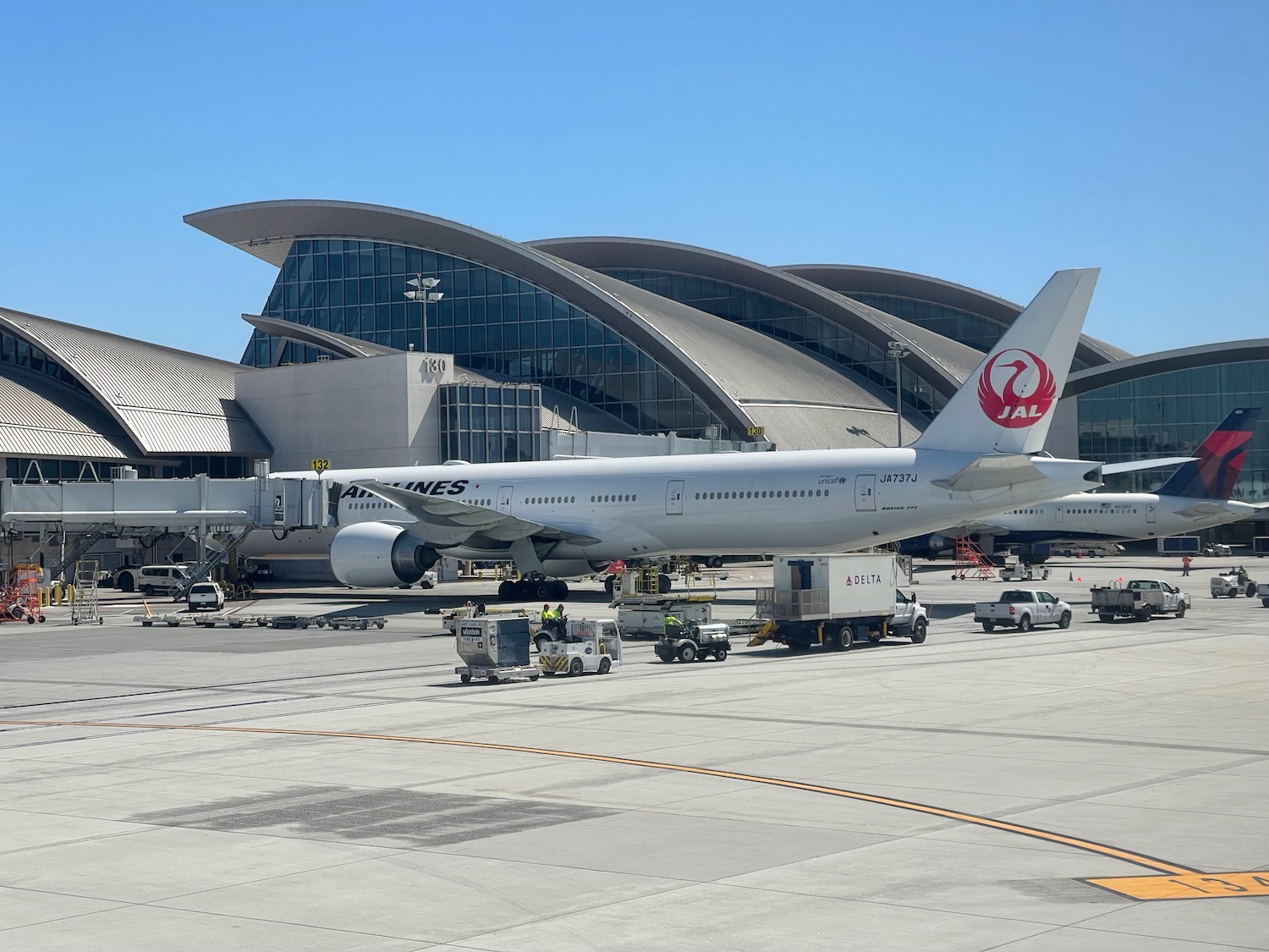 a large white airplane parked in front of a building