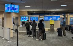 people standing in front of a computer