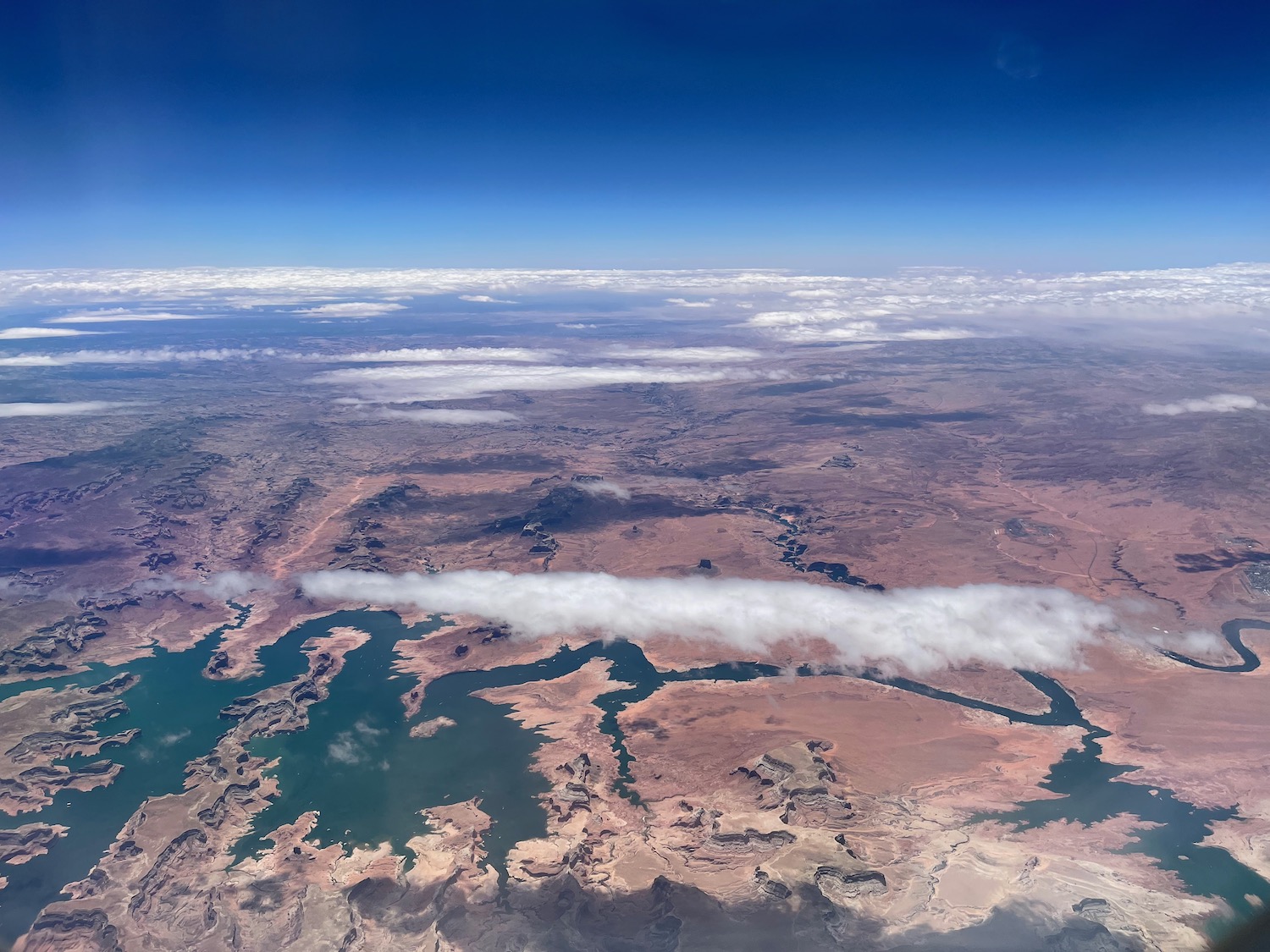 aerial view of a landscape with clouds and water