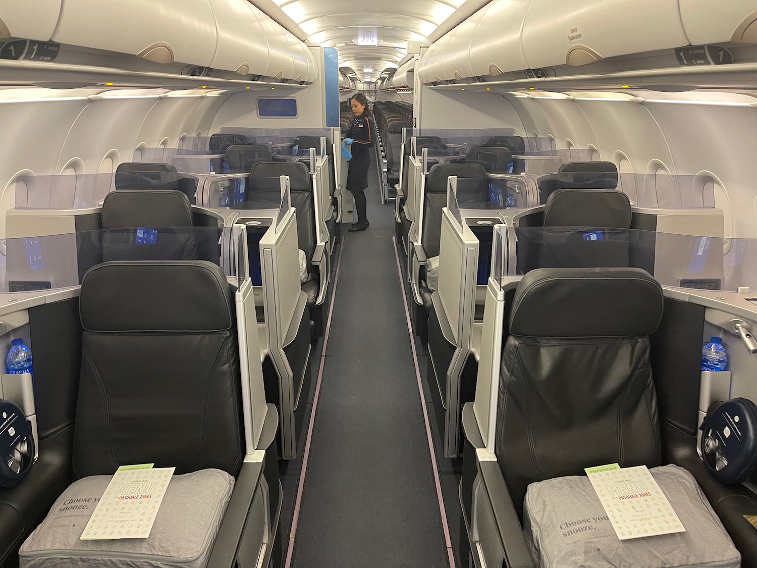 a person standing in the aisle of an airplane