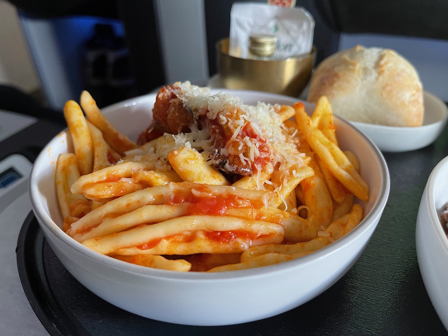 a bowl of pasta with cheese and bread