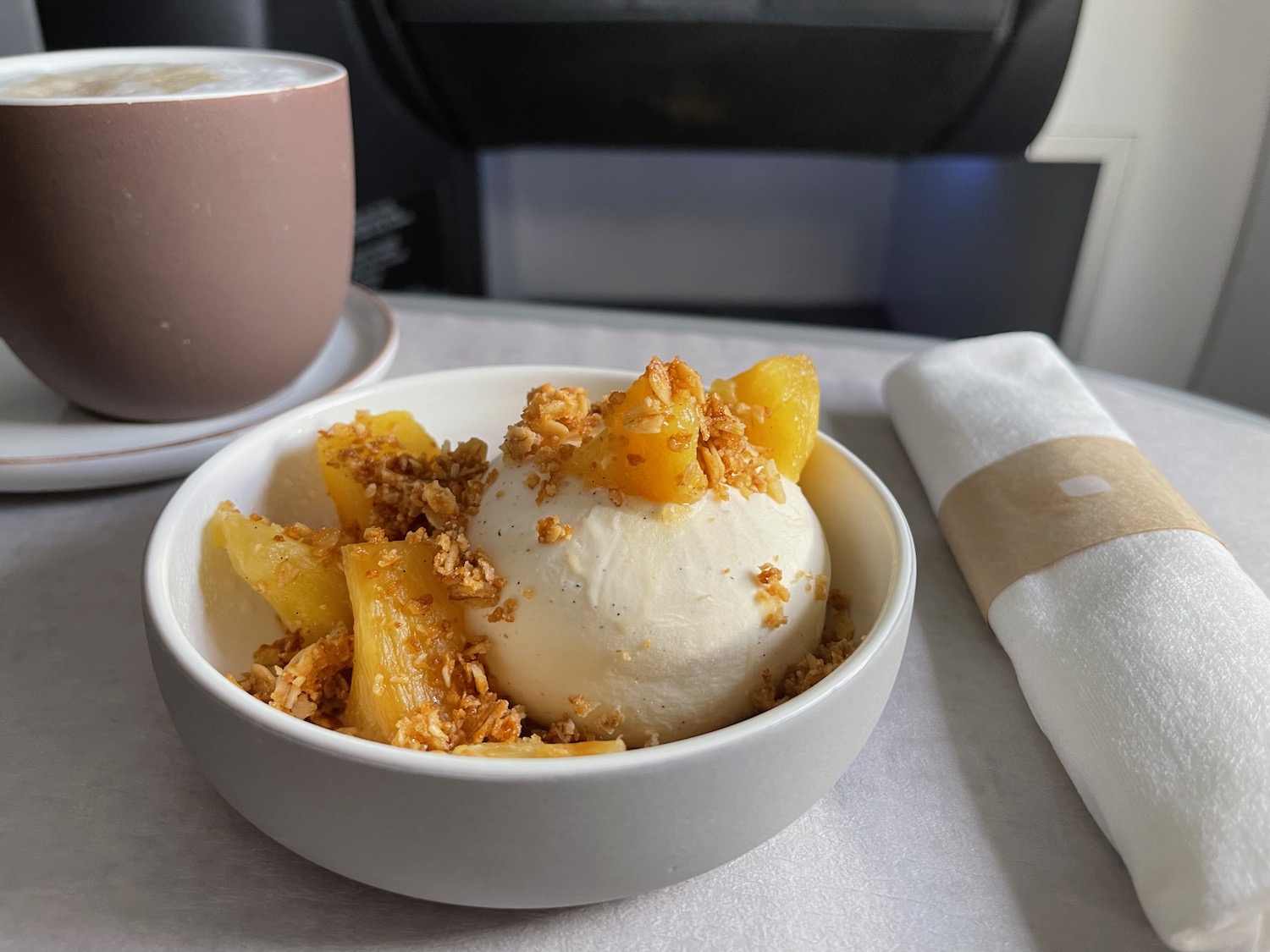 a bowl of ice cream with fruit and granola